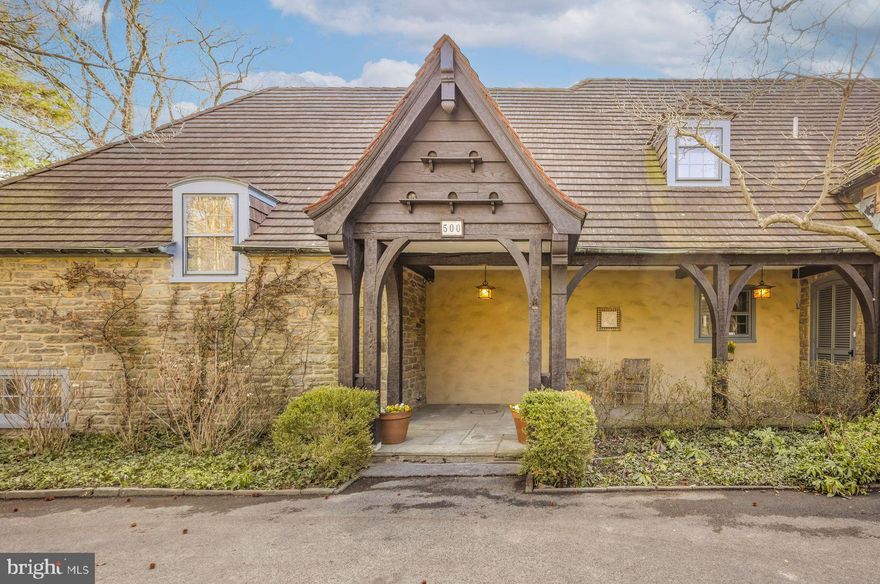 Welcome to 500 Telner Street, one of the finest Woodward houses in Chestnut Hill. Built in 1957, but resembling a 1925 house typical of the aesthetics of Chestnut Hill, this lovely estate was custom built for George Woodward, Jr. and his wife Harriet for their personal home. The Woodward family is well-known for building Chestnut Hill’s most charming estates. Its park-like setting and charming dovecote gracing the front entrance, surrounded by pink azaleas in Spring, make this fairy tale “cottage” come to life. This is one of the rare homes directly on Wissahickon Valley Park. Timeless charm, so typical in Woodward architecture, is brought to its zenith in this stone home, custom built to plans now archived at the Chestnut Hill Conservancy, with seemingly no expense spared. All the modern amenities you love, such as central air, a full 2 car garage, an attached separate apartment with its own private entrance, 5 full and 3 half baths (each bedroom and apartment with their own full bath), and enormous closets and attic space, offer comfort and convenience. With 8 inch deep granite window sills due to the thick walls, the house is exceptionally quiet due to the insulation, solid doors and stucco walls. Uniquely, the primary bedroom suite occupies an entire wing on the ground floor and features a spacious bath with dual bathrooms, each with its own shower or tub. The generous bedroom includes French doors opening to a private patio, a marble fireplace, built-in dresser, and separate closets, along with an adjoining sitting room with an additional marble fireplace. This wing creates total privacy from the other living spaces in the house. The grand living room, with an open floor plan connecting to the dining room, boasts 5 sets of French doors that are lit with morning sun, with an unobscured view filled with trees as it overlooks Cresheim Valley. Since 2013, multiple improvements have been made, including a new main kitchen with radiant floor heating, a Miele dish washer, Viking stove, convection oven, and a generous pantry complete with a cozy, sunny home office. The kitchen in the apartment is also new, with granite countertops, gas range and dishwasher, and added in 2020, a spacious southern exposure insulated glass addition opens out from the living room for your hot tub, 4 season relaxation and plant cultivation or display. A kitchenette is also located here. The circular and garage access driveways were repaved in 2023. The generous studio apartment has a separate entrance and contains multiple windows, a full bath and ample closets. The second floor contains 3 bedrooms and luxuriously, one full bath for each bedroom. Adding to the home's flexible layout is the possibility of complete separation of upstairs and downstairs due to the private entrance access to both the upstairs and the apartment. A large slate floor foyer at the front door absorbs all the comings and goings and stands the test of time. Located over the furnace room, the slate remains warm all winter long. A massive “playroom” in the finished basement, complete with fireplace, could be an exercise space, a guest bedroom (it has a large window), office, child or party space. While laundry is conveniently located on the ground floor, there is plumbing here in a large closet for another laundry facility. There is also a half bath in the basement and a very generous workshop space as well. An additional finished room which, at the owner’s option, could be reserved for the resident of the apartment to enlarge its capacity, or kept as part of the main residence.
