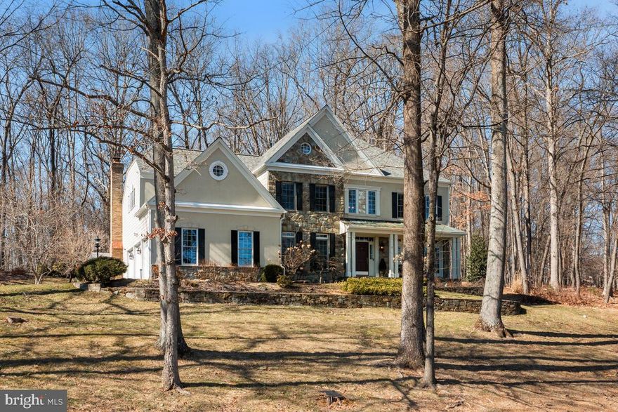 Welcome to 14228 Cervantes Avenue, a stunning Winchester-built estate nestled on a tranquil and picturesque two-acre lot in the heart of Darnestown. Boasting 6,304 square feet across three beautifully designed levels, this home blends elegance, comfort, and modern luxury, offering an unparalleled lifestyle in a serene yet convenient setting.

From the moment you arrive, the striking stucco and stone façade, complemented by a flagstone-covered front porch, sets the stage for the exceptional craftsmanship within. Step into the grand two-story foyer, where recently installed hardwood floors flow seamlessly throughout the main level, staircase, upstairs foyer, and primary suite.

The renovated gourmet kitchen is a chef’s dream, featuring top-of-the-line Subzero, Wolf, and KitchenAid appliances, quartzite countertops and backsplash, a built-in microwave, warming drawer, hot water tap, motion-sensor faucet, and a stylish wet bar—perfect for entertaining. A generous sunroom extends off the kitchen, kept comfortable year-round with its own dedicated heat pump, making it the perfect spot to sip morning coffee while enjoying breathtaking views of the lush backyard.

Designed with both elegance and convenience in mind, the main level also boasts a front and back staircase, a spacious formal dining room ideal for hosting memorable gatherings, a formal living room with double French doors leading to the covered front porch, and a stunning family room with vaulted ceilings and a striking stone fireplace. A private office with custom built-in bookshelves and recessed lighting sits just off the foyer, offering a sophisticated workspace.

Upstairs, the luxurious primary suite offers a private retreat with a spacious sitting area, walk-in closet, and spa-like ensuite featuring a separate jetted tub, standing shower, dual vanities, and a private water closet. Three additional large bedrooms complete the upper level—one with its own private ensuite and two connected by a Jack and Jill bath with a separate bath/shower area and dual vanity.

The fully finished basement is an entertainer’s dream, boasting a custom bar and rec room, a temperature-controlled wine cellar with an adjacent tasting room, a home theater for movie nights, a private bonus room, and a den currently used as a sleeping area. A custom full bath and convenient walk-up exit complete this versatile lower level.

Step outside and experience the beauty of this expansive two-acre lot, a peaceful oasis where you can unwind, entertain, and embrace the outdoors. The flat upper-level backyard is ready for your vision—whether it's a sport court, pool, or garden retreat. A flagstone patio provides the perfect backdrop for outdoor dining, summer barbecues, or simply relaxing under the stars.

Additional highlights include: three-zone heating and air conditioning with gas heating, a large three-car garage with built-in cabinets and a custom epoxy floor, perfect for your luxury vehicles, a brand-new 50-year-rated architectural shingle roof (October 2024), upgraded James Hardie plank siding, and energy-efficient windows.

While this home offers a private, peaceful escape, it's also ideally situated just minutes from top-rated schools, local parks, and premier shopping and dining. Enjoy easy access to major commuter routes including I-270, Route 28, and the ICC, making travel to Rockville, Bethesda, and Washington, D.C. a breeze. Outdoor enthusiasts will love the nearby hiking and biking trails, golf courses, and equestrian facilities, while everyday conveniences are just a short drive away.

This exceptional home offers not just a place to live, but a lifestyle to love—where luxury, tranquility, and convenience come together in perfect harmony.