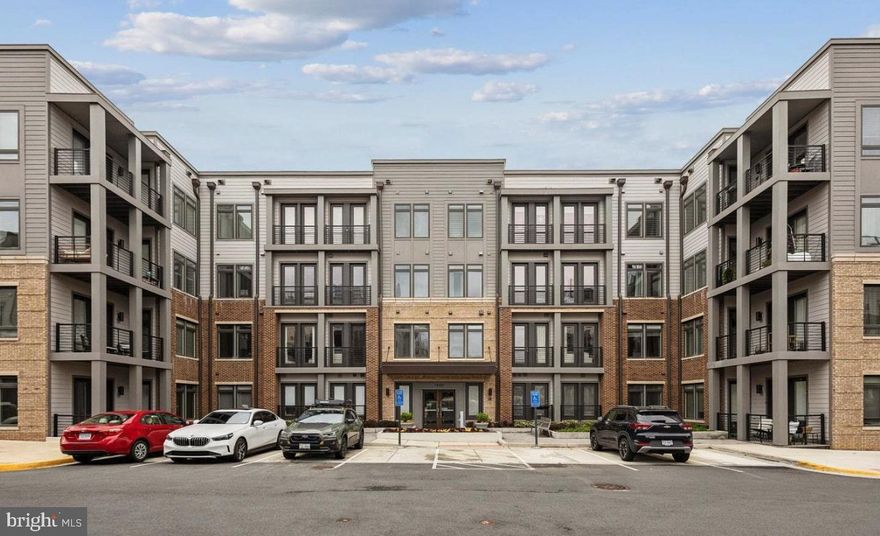 Welcome to this stunning, modern condo in the desirable Tall Oaks new community, built in 2022 by Stanley Martin. With its luxurious blend of high-end finishes, sleek WiFi enabled appliances, and hardwood LVP flooring throughout, this bottom-unit retreat exudes sophistication and charm. This condo's open floor plan features high ceilings, a gourmet kitchen, perfect for entertaining. The expansive balcony offers serene views, ideal for relaxing or enjoying a morning coffee. Plus, this unit comes with the added convenience of an assigned wired electrical vehicle hookup, making it an eco-friendly haven for electric vehicle owners. Enjoy the ultimate blend of luxury and convenience, with nearby walking trails, Reston community pools, and walking distance to the Wiehle-Reston Metro. Perfect for professionals, commuters, and those seeking a low-maintenance lifestyle, this condo provides the ease of one-level living with zero exterior maintenance. Nestled in a peaceful setting, yet just minutes from Plaza America, Reston Town Center, and Dulles Airport, this condo offers the perfect balance of tranquility and accessibility. Come experience the epitome of modern luxury living in this stunning Tall Oaks condo! This is the one!