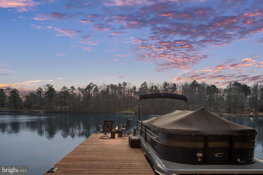 Introducing a breathtaking lakefront retreat that combines luxury living with serene natural beauty! Perfectly situated at the end of the lake, ensuring a peaceful atmosphere with minimal boat traffic. This stunning property offers captivating views of the lake and provides the perfect escape for water enthusiasts and nature lovers alike! Enjoy the convenience of a private boat dock and lift! The open-concept design features a modern kitchen equipped with high-end appliances and a large island, an inviting living area for entertaining, and large windows that flood the living space with natural light while providing spectacular views of the water. This spacious residence features two beautifully renovated primary suits, each with its own luxurious bathroom and large walk-in closets. One primary is located on the upper level and one on the main. The main floor also includes two other bedrooms and a full bathroom in the hall. For added convenience the laundry is located on the main level. The home offers ample storage in various areas. Additionally, the extensively finished basement features substantial extra space, a fifth bedroom (not built to code), a full bathroom, and a second laundry hookup. Step outside onto the impressive Trex deck that spans the entire length of the home, providing the perfect spot for relaxation and entertainment while taking in the water views. The concrete patio below offers additional outdoor space. There is an attached storage shed to keep your lawn equipment plus an impressive heated oversized garage which is a true standout, providing ample space for your vehicles, lake gear, and more! With a large countertop and abundant cabinetry, it is perfect for DIY projects, hobbies, or simply keeping everything organized and easily accessible. It also comes with hard wired electric vehicle hook-up. Located in a resort-like community, enjoy a wealth of amenities including a sandy beach, swimming pool, basketball, tennis, pickleball courts, fishing piers, multiple tot lots, and picnic areas. Don’t miss this opportunity to own a slice of paradise—schedule your showing today!