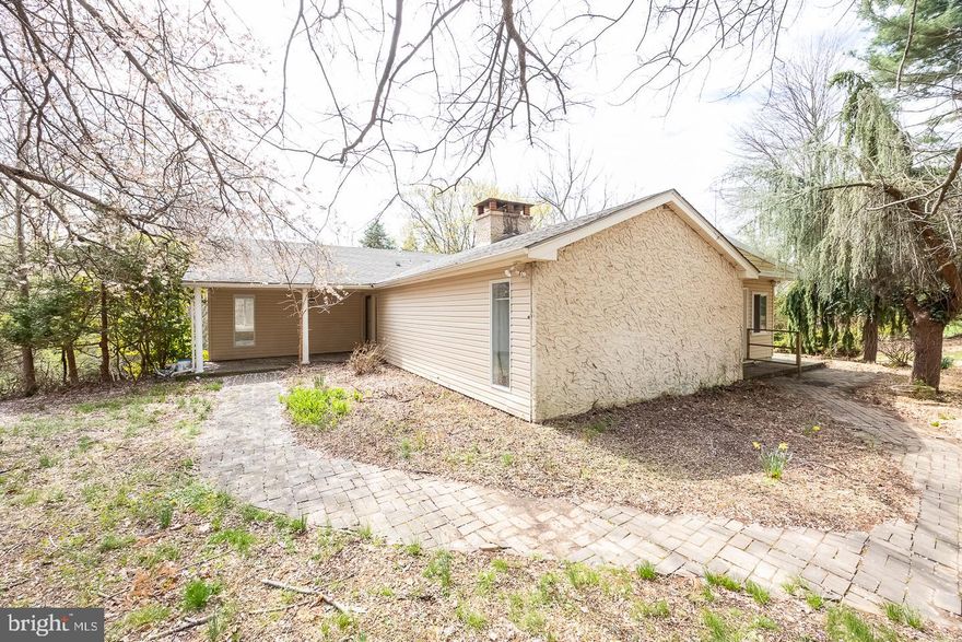 **** OFFER DEADLINE 4/22 AT 5PM **** Welcome to 312 Larchwood Road – a one-of-a-kind rancher tucked away on a private, partially wooded lot just minutes from the heart of West Chester Boro. This is no cookie-cutter home – from its multiple entrances and outdoor patios to the charming paver walkway that seamlessly connects each space, every inch of this property offers character and charm. The bright and inviting living room features stunning built-in bookcases with arched accents and a double-sided fireplace, adding warmth and elegance to both sides of the wall.  The kitchen showcases an abundance of crisp white cabinetry, contrasting countertops, stainless steel appliances, tile flooring, and a peninsula with bar seating – perfect for entertaining. The adjacent dining room offers a built-in buffet and shelving, ideal for gatherings and extra storage. Step into the stunning sunroom addition – a true showstopper with hardwood floors, skylights, a statement chandelier, and walls of windows that flood the space with natural light and tranquil views. Down the hall, you'll find a spacious primary suite with a unique walk-through closet, a built-in bench overlooking the rear yard, and a private ensuite bath. Two additional generously sized bedrooms and a centrally located hall bath provide ample space for family, guests, or a home office.  Convenience is key with main floor laundry, and the mostly finished lower level offers bonus living space, a half bath, and walk-out sliders – ready for your final touches.  The long driveway leads to an attached two-car garage, offering plenty of parking. Enjoy the serenity of this tucked-away location while still being just minutes from West Chester's boutiques, restaurants, and shopping, with easy access to major routes of transportation.  Don’t miss this opportunity to own a unique and spacious home in a prime location – schedule your tour today!