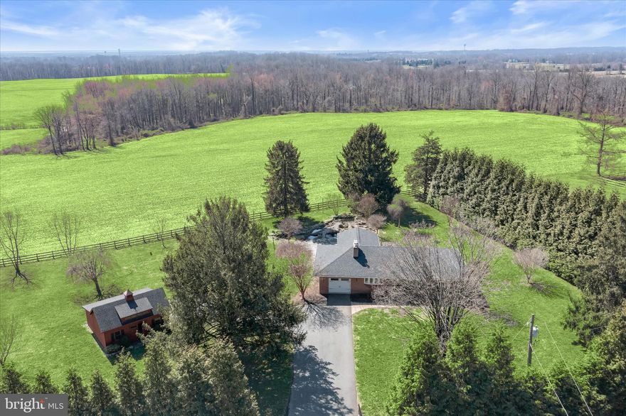 Surrounded by nature on 2.2 scenic acres with tranquil pasture views, this inviting 3BR, 2BA brick rancher with over 2,400 sq ft and a finished lower level offers a peaceful retreat with exceptional indoor and outdoor living. Beautiful hardscaping, a soothing waterfall koi pond, bluestone patio, and Amish-built barn create a truly picturesque setting. Inside, enjoy hardwood floors, updated baths, a stone surround wood-burning fireplace, and an updated eat-in kitchen with granite counters, stainless steel appliances, breakfast bar, and 42” cabinetry. The vaulted all-season sunroom is wrapped in windows showcasing panoramic views. Finished lower level includes rec room, fireplace, full bath, workshop area, and walk-up access. Convenient to APG, I-95, and local amenities.