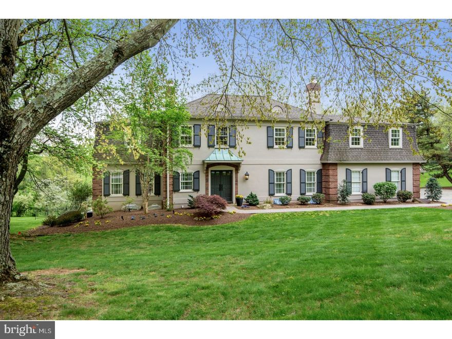 A stately, sprawling home, this quintessential Main Line Colonial in a beautiful Gladwyne neighborhood sits on 2.5 breathtaking acres, in a prime location just a mile to the entrance of Philadelphia Country Club. Views from the rear overlook protected wooded acreage. Expansive lawn is perfect for games. The pristine-condition interior offers the open floorplan modern families desire, along with exquisite woodwork & classic architectural elements that lend wonderful character. From the formal to the casual, every room is used & enjoyed to the fullest! Double front doors open to a gracious reception hall with a coat closet, powder room & hardwood floors that spill throughout the 1st floor. The spacious living room with triple exposures & a fireplace offers double glass doors that open onto the rear covered deck with skylights for easy indoor-outdoor entertaining. A formal dining room graced by decorative moldings affords a lovely setting for sit-down meals. The open-plan gourmet granite & stainless steel center island kitchen, breakfast room overlooking the rear grounds & family room with fireplace keeps the cook connected with friends & loved ones. Glass doors from the family room also extend the living space to the deck outdoors for fabulous summer parties. A mudroom accesses the laundry room with a chute from upstairs, and a 2-car garage with storage is great for cars & equipment. On the 2nd level, beautified by hardwood flooring, are 5 generously-sized bedrooms, the highlight being the master suite with built-in cabinetry, walk-in closets, a dressing area & luxurious marble bath, all in its own wing. A bonus room/home office/BR with built-in shelving, 2 full baths & abundant closets complete this comfortable level, and a walk-up carpeted 3rd floor provides plentiful storage. The day-lit walk-out lower level has a nicely-finished recreation room with a gas fireplace where the all will love to hang out, and glass doors to the covered patio. A sunny windowed exercise room also has French doors to outside. A powder room, 2 closets & a utility room with plenty of space for a 2nd fridge & freezer, cleaning & household supplies, etc. is a great extra. This address easily accesses major routes to Center City & many local conveniences.