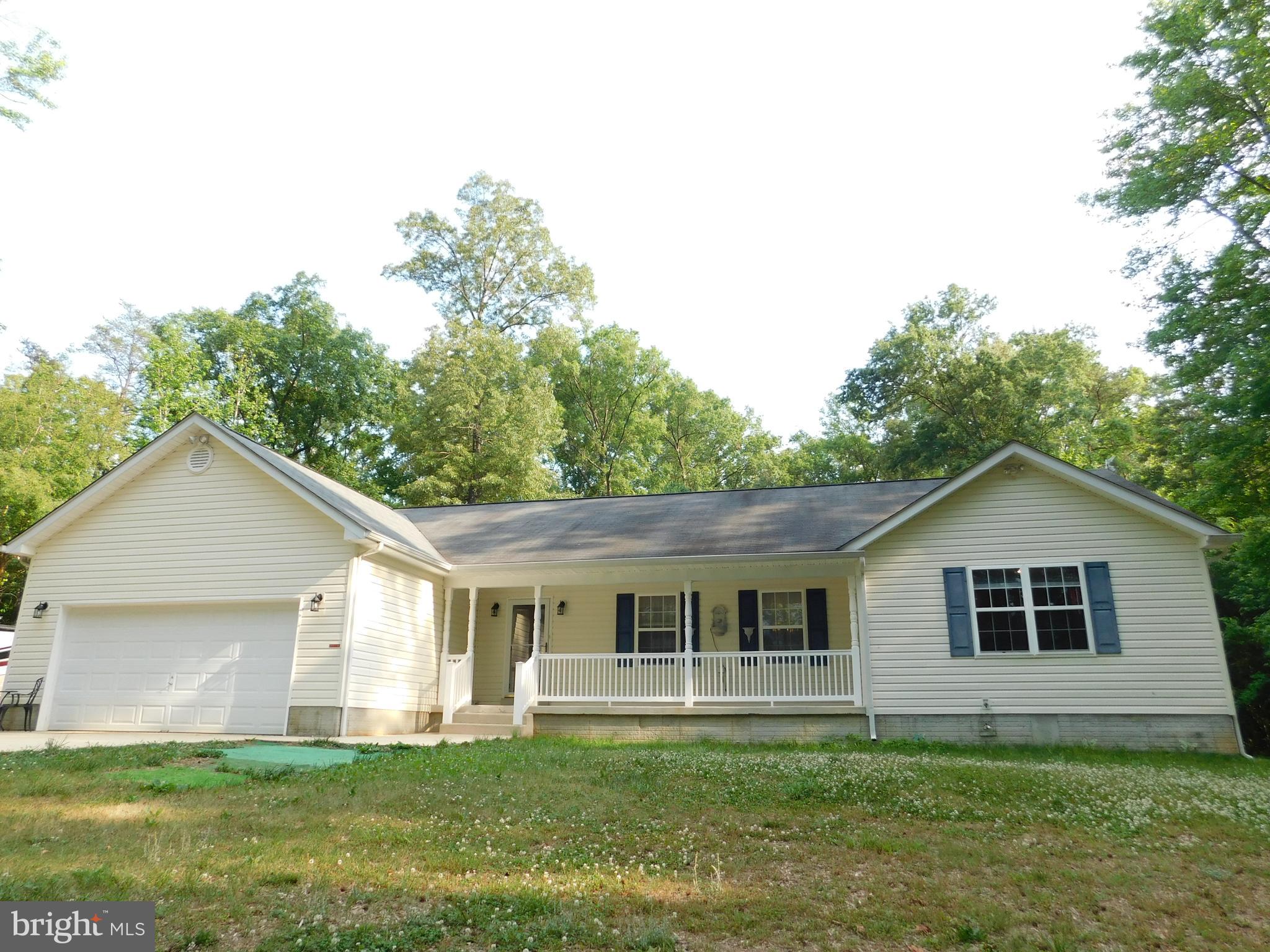 Take to the woods and celebrate nature in country comfort! Privately sited on more than 6 acres, this remarkable rambler is sure to delight as your options are many. From the generous covered front porch, enter onto the foyer and you are greeted by an open floor plan where all can gather to enjoy a meal, a movie, or whatever your heart's desire. Here you'll find a large country kitchen, with breakfast bar, that is open to the dining area and living room. Known as a split design, the master bedroom is located at one end of the home and this one features a private bath and walk-in closet. As a matter of privacy, 2 additional bedrooms are located on the other end of the home with a full hall bath in between. The home offers a full unfinished basement that is ready to be finished to your personal taste and preference. The basement is where you will find the laundry area, a laundry tub, working toilet, and French doors that lead to an area way walk-up exit. The home also features a 2-car front loading garage, complete with a garage door opener. For the outdoor enthusiasts, there are many options from which to choose. You could lounge on the front porch and watch for grazing deer or wild turkeys meandering in the field across the country road. Or, everyone might chose to hang out on the rear deck for a bar-b-que, while listening to your favorite tunes and maybe taking a swim in the 17' heated swim spa - a HUGE bonus! Someone might choose to shoot hoops on the court, play on the playset, or just relax in a lawn chair at one of the sitting areas. If it starts to rain, no worries, there's a large covered area on the deck. To the rear of the property, you'll have your own extensive trail system, great for a nature walk or riding bikes and 4-wheelers. To protect and store your outdoor lawn and sports equipment, and then some, there is a large shed, which convey with the property. You'll also be happy to know that nearby is a community center, as well as a boat ramp so you can get on the river to fish or explore. This truly is a fabulous property for those who are looking for privacy and who enjoy the great outdoors. If you responded with a YES to some or all of the above features and amenities, be sure to schedule your showing as soon as possible!