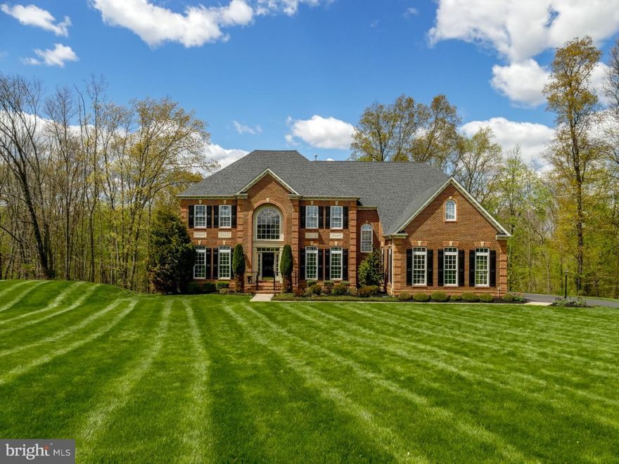 Style, class and elegance are evident as you tour this distinct quality constructed NV Home on a premium secluded lot located in the prestigious Warner Meadow Community. Enter into a spectacular 2-story reception hall with grand dual staircases, gleaming h/w floors and open side by side formal living and dining room arrangement. The highlight is the expansive gourmet kitchen designed with 42' Timberlake cabinets, granite countertop, island, top-grade stainless steel appliances, butler kitchen and intricate iridescent glass tile back splash. The morning sun room is adjacent to the kitchen as is a 2-story family room with custom built-in mahogany cabinetry, gas fire place and a wall of windows overseeing a private wooded backyard and its newly constructed wrap around designer Trex deck and lower level paver patio. A powder room and light-drenched office/study with bay windows complete the 1st floor with 10 ft. ceilings throughout. Upstairs admire taste and sophistication in the gorgeous master bedroom suite with sitting area and well appointed private spa retreat Roman master bath. The oval center tub compliments the lavish oversized frameless dual shower and his/her vanity with entrance to a dressing room with custom built-ins. Each of the three additional bedrooms has its own bathroom with cherry cabinets and granite tops. Exquisite architectural details and molding on walls, ceilings, columns, windows and doors are found throughout this incredible structure. The walk-out basement provides approx. 1,800 sq.ft. finished space, featuring a huge recreational area with custom full bar, billiard, media and 5th bedroom with full 5th bathroom. The 6th bonus room with walk-in closet close by can be utilized as another bedroom, exercise room or office space converting the basement given into an ultimate In-Law-Suite. French doors will let you exit to an extraordinary patio constructed in 2014 as well as the deck with first quality textured surfaces and custom outdoor kitchen "Fire Magic" gas grill with half moon shaped granite counter top/bar and fire pit. A large fully enclosed and waterproofed storage area under the deck provides a unique and dramatic finish to this outdoor oasis making it pleasing and practical to every entertainers delight. Inviting grounds and professional landscaping are executed to a masterful outdoor space. Close to major arteries and the award winning CR school district. This fantastic home will meet your every expectation!