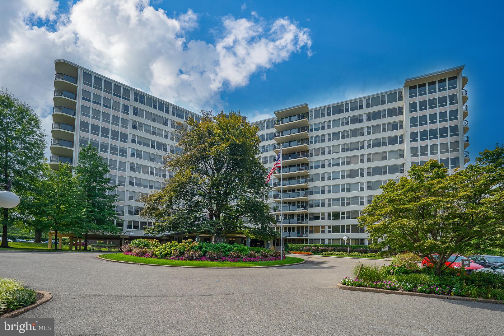 Welcome to Sutton Terrace, located in the heart of Bala Cynwyd where comfort, convenience, and style come together in this spacious two-bedroom, two-bathroom unit offering true one-floor living.Step through the foyer into an open-concept Living Room, Dining Room, and Kitchen layout that’s perfect for modern living. The sun-drenched Living Room features a wall of windows that face the pool and flood the space with natural light and offer serene treetop views. Sliders lead out to a generous private balcony, perfect for relaxing or entertaining. The Dining Room flows seamlessly into the expansive Eat-in Kitchen, complete with stainless steel appliances, a pantry, abundant cabinetry, a peninsula with seating for four, and space for a table—currently used as a cozy library and reading nook. Down the hall, the spacious Primary Bedroom offers two closets—including a walk-in—plus a ceiling fan and wall of windows. Double doors lead into the luxurious Primary Bathroom, featuring a double vanity, jetted tub, separate frameless glass shower with bench seating, and recessed lighting. A second Bedroom with two closets and a very large Hall Bathroom (the size unlike others in this building) offers a frameless glass shower, linen closet, and stylish vanity. Washer and Dryer in unit! This is a full-service building with 24-hour doorman, fitness center, library, social room, and seasonal outdoor swimming pool. Conveniently located with easy access to the city, public transportation, restaurants, and shopping. Outdoor parking included, with garage parking available for rent when available. This beautifully maintained unit is a must-see!