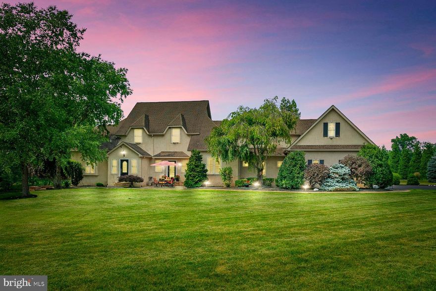 Exceptional 4000+ sq ft.  Country French Colonial on 3.8 Acres Loaded with Custom features, millwork and built-ins throughout PLUS an unbelievable detached workshop building containing approx. 5600+/- square feet  featuring a 1200 sq ft  6 car garage and 2000 sq. ft workshop with restroom on the main floor plus a stunning finished second floor with many custom features and a full bath.  This detached workshop hi-quality cut brick building is ideal for the contractor, car collector, woodworker, artist or hobbyist. The Main home features an EP Henry style front walk and patio leading to the Entry Foyer and hall leading to the stairs to second floor and exit to the rear patio , a large living room (owner currently uses as a huge dining/sitting room, dining room (currently used as a den), Family room with Pellet stove/Fireplace, Ultra kitchen offering a big central Island, 2 ovens, propane cooktop, Granite counter-tops and C/T Flooring, the breakfast room has a cathedral ceiling, back stairs and outside exit to the huge rear patio, main floor laundry and powder room are close by plus exit into the 3 car attached side entrance gargage. The Main bedroom located on the main floor offers a cathedral ceiling, big custom organized closet, plus the Main Bedroom 4 piece bath with stall shower, claw footed tub and marble flooring.  There is a stair case from the 1st flr Main Bedroom to a second floor sitting room/loft overlooking the main bedroom and you can access the second floor hall from this room. The Second floor offers 3 bedrooms (one with en suite bath), a hall bath and a den/game room. There is a door to an unfloored attic area from the second floor den to a large area that could be expanded into what would make a great large bedroom suite. All three second floor bedrooms have vaulted ceilings. The finished basement has a theater area with projection equipment included, a table area, a full wet bar with stools included, an area ideal for a pool or gaming table, a gym room with custom lighting, a full bathroom, and walk out to a patio and koi pond. There is also a large storage/utility room with a sink. This home has 2 hi-efficiency Propane heating/A/C systems, Propane hot water heater and the well with Softener and Neutralizer. The home is served by 200 Amp electrical system with a 100 Amp sub-panel.  The rear patio accessed from the main level offers plenty of room to entertain a big group plus a pavilion with sunken seating and a large charcoal (or wood burning) grill. The detached workshop, in addition to the main floor, offers a huge second floor that is great for entertaining, a studio, displaying memorabilia, etc. as it provides a large Living room area with many built-ins, a big dining area with a wood/pellet stove with table and chairs to seat 12, a long custom fully equipped Bar with 9 stools, there is a door to the rear for a future deck, an office area, a full bath with a walk in shower, under eave storage, a utility closet, and a store room with double door to bring up large items. Heat is propane fired and there is 400 Amp service. Also, there is a one story addition to this workshop building to house a lawn tractor and garden equipment. This fine property has way too many quality features and extras to list and must be seen to fully understand what is here. A rare opportunity to have your work or hobby at your home-yet separated.