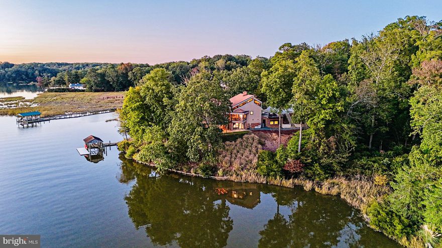Waterfront Architectural Masterpiece - skillfully designed to capture every spectacular angle of its remarkable 650 linear feet of water frontage. Privacy permeates the 4+ acre estate while offering sweeping views of College Creek and the James River in the distance. Designed by world-renowned artist and architect, this treasure of a home offers a tranquil escape from the ordinary. The geometric work of art - crafted with only the finest materials - was completely renovated and expanded in 2017 and 2021 while staying true to its original design. The property boasts an indulgent owner’s suite, panoramic water views, a theater with 2 loft balconies, a state-of-the-art sauna, covered boathouse and floating dock - for deep-water boating enthusiasts, 2 kitchens, a project room, and much more. Stunning sunsets pour through the home's southwest-facing windows. This private oasis, nestled in the heart of Williamsburg, is minutes from renowned College of William & Mary and Historic Williamsburg.