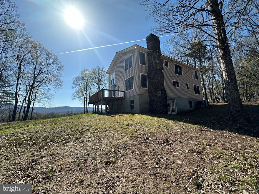 THE FALLS.....SPACIOUS CONTEMPORARY HOME ON 55 PRIVATE WOODED ACRES WITH INCREDIBLE MOUNTAIN VIEWS AND BOLD STREAM WITH MULTIPLE MAGNIFICENT WATERFALLS! TUCKED AWAY ON A SECLUDED RIDGE ONLY 1/2 MILE OFF THE COUNTY ROAD AND 1.5 MILES FROM PUBLIC ACCESS ON WV'S CLEANEST RIVER "THE CACAPON".... YOU'LL FIND THIS RECREATIONAL PARADISE THAT CHECKS EVERY BOX......HUGE VIEWS, YEAR ROUND STREAM FLOWING THROUGH PROPERTY & TOTAL PRIVACY! HUNT, SHOOT, RIDE YOUR ATV TO THE RIVER AND DROP A LINE.....IF YOU COVET THE OUTDOOR LIFESTYLE, THIS PROPERTY WILL NOT DISAPPOINT! HOME FEATURES 5 BEDROOMS & 3.5 BATHS, HARDWOOD FLOORS THROUGHOUT, TONS OF NATURAL LIGHT & 2 SCREENED BALCONIES. A LITTLE UPDATING & TLC NEEDED, EVERYTHING ORIGINAL FROM MID 1990'S BUT IT'S WORTH THE EFFORT, YOU COULDN'T EVEN COME CLOSE TO BUILDING THIS HOME FOR 500K AT TODAYS PRICES. CONVEYS TURNKEY & READY TO ENJOY! THE LAND IS LOADED WITH GAME AND IS COVERED IN MATURE HARDWOODS & GLORIOUS WHITE PINES, RUGGED BUT BEAUTIFUL. WHETHER YOU'RE SEEKING A WEEKEND OASIS, FULL TIME HOME OR AN AIRBNB ATM MACHINE$$$$ THIS PLACE IS A FIT. GET THAT MIDDLE NOWHERE FEELING ONLY 110 MILES WEST OF THE WHITE HOUSE & ONLY 30 MINUTES NORTHWEST OF WINCHESTER, VA. AN EXCEPTIONAL PROPERTY AT AN EXCEPTIONAL PRICE, IF YOU WERE STARTING FROM SCRATCH, YOU'D NEED CLOSE TO A MILLION BUCKS TO REPLICATE. MAKE THE CALL, TAKE THE DRIVE, WRITE THE CHECK AND START LIVING YOUR BEST LIFE IN ALMOST HEAVEN!