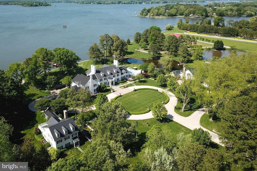 Arguably the best offering on the Eastern shore, qualities of grace and authenticity are at the heart of every aspect of the design, renovation and re-creation of the grounds, house and outbuildings of this magnificent estate. Located between the towns of St. Michael's and Easton, Maryland, this turnkey property prioritizes water views, outdoor living areas, and lovely furnishings to create a place for large family gatherings. This country, waterfront retreat was designed by architect G.L. Smith Associates and renovated and expanded by Visnic Homes. Overlooking the Miles River with sweeping views, the estate offers a tranquil vibe with a perfect blend of elegance and comfort.Part of the main house renovation and expansion included opening up the home to incorporate water views and create a view from the front entry through to the rear foyer. A radial sun room was added at the end of the front hall foyer featuring curved walls to maximize the panoramic views. This room is breathtaking and provides the perfect spot to sip morning coffee while reading the newspaper or your favorite book. The most significant characteristic of the interior architecture and construction is the great room, featuring a WWII fighter plane replica hung upside down.Transforming the landscape literally left no stone un-turned. Work included adding the improved main entrance and driveway, a new pool and pool area with a fireplace and pergola-covered seating, tidal pond restoration, new paths, walkways and sidewalks. Central to the landscape, however, is the art and architecture, including sculptures side by side with flowers, shrubs, and imagined church "ruins" designed and inspired by the homeowner's native England. A garden of climbing roses and Boston ivy help create the impression of a church abandoned hundreds of years ago, a perfect spot for a wedding or religious event.Symmetry is evident on the grounds with the revised main entrance and redesign of the two flanking outbuildings that create cohesiveness on the property. On the right side, the original existing barn was transformed into a caretaker's cottage and garage to match the main residence's style. The cottage offers 1 bedroom + den and full bathroom.  The outbuilding to the left was transformed into a spectacular guesthouse with water views, connected to the main home with a newly constructed breezeway.  The guest offers 3 bedrooms and 2 full baths, kitchen, laundry. living room & dining room.  The rest of the approximate 36 acre estate offers a four stall barn, multiple paddocks, airplane hangar, 1800 foot grass runway, two bedroom farmhouse, large equipment barn, rip-rapped shore line, pond, and private dock with electric boat and jet ski  lifts.This property has four residences. The number of bedrooms is larger than in MLS.  Main house offers 6 Bedrooms, 5 full baths, 4 half baths.  The guest house offers 3 bedrooms, 2 baths.  The guest cottage offers 1 bedroom, 1 bath.   The caretakers house offers 2 bedrooms, 1 bath. Co-lister Marc Bertinelli