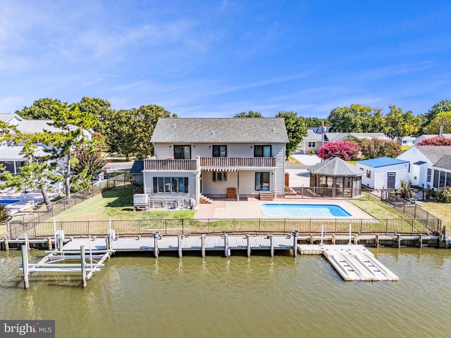 Waterfront Living at Its Finest!
This stunning 4-bedroom, 3.5-bath saltbox-style home sits directly on the canal, complete with a private dock, boat slip with lift, and a floating dock for two jet skis—offering direct water access to Rehoboth Bay and Love Creek.

The backyard is a true retreat, featuring an in-ground pool, fenced yard, and a covered awning—perfect for entertaining. Inside, the first floor boasts hardwood floors, high ceilings, a cozy gas fireplace, and a sunroom filled with natural light. The gourmet kitchen is equipped with stainless steel appliances, granite countertops, a gas range, wine fridge, and trash compactor. The first-floor primary suite includes patio access and a private bath. Additional highlights include a half bath, oversized laundry/mudroom, and a two-car garage.

Upstairs, a dramatic balcony overlooks the main level. Three spacious bedrooms include a second primary suite with a massive walk-in closet and cedar closet. All bedrooms have access to a shared balcony with sweeping views of the pool, canal, and Rehoboth Bay.

With no HOA, and just minutes from shopping, dining, healthcare, and entertainment, this home combines convenience, luxury, and the ultimate coastal lifestyle.  Schedule your private showing now!