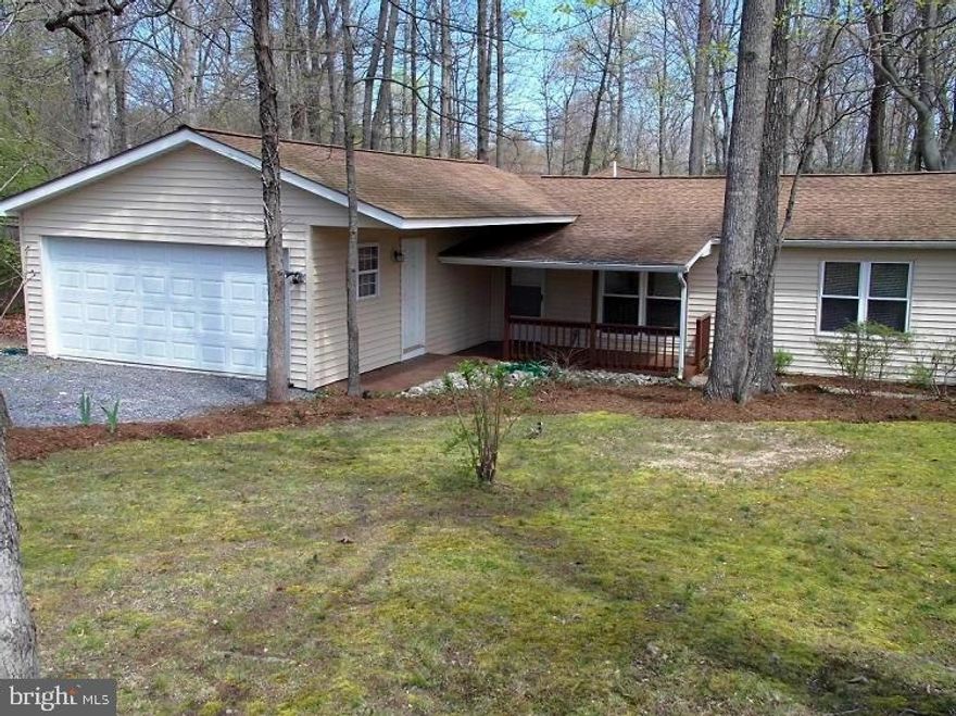 This beautiful Rambler has recently undergone a COMPLETE RENOVATION and shows like a BRAND NEW home!  It features  NEW bathrooms and a remodeled kitchen with all NEW appliances and fixtures.   All rooms are BRIGHT with NEW paint and flooring, and ALMOST new windows ,  doors and ceiling fans/lights.  This is a 3 bedroom house, BUT a large room off the family room COULD EASILY be used an office, den or even a place for another bed for overnight guests to sleep.  The laundry is large enough to also serve as a sewing room, or an area for hobbies or extra storage.  The owners went to considerable effort and expense to ensure the Crawl Space is in good condition and completely waterproofed. The 2 car garage has plenty of room for a workshop. The main driveway will accommodate 4 vehicles. AND there is a second driveway off the side street.  The home is located on an AWESOME well maintained 1/3 + acre corner lot with a rear rustic fence with a wire back up to keep pets in the  yard.   Great outdoor FAMILY events can be enjoyed on the great rear deck.  The barn shed has electricity and will house lots of garden equipment.  This wonderful property is  within WALKING DISTANCE to  the fresh water Lake  Lariat Beach and Playground and the Chesapeake Ranch Estates Campground .  Your friends and family can visit with their RVs and only be a city block away.  TWO community private BAY BEACHES for picnics or sunbathing are nearby. There is even a 2500 ft. paved airstrip for private pilots to use. This nice home truly offers a young family SO MANY possibilities and features not found in most communities within  Southern Maryland.   It is FRESH and READY TO GO!  You should SEE IT SOON!!!