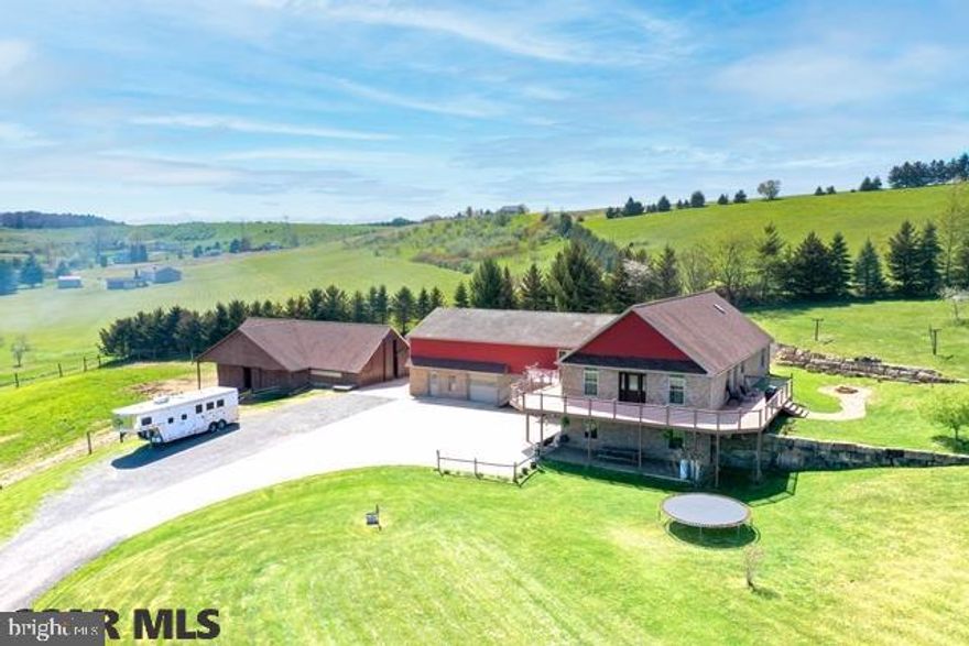 Magnificent 5 BR, 3 1/2 BA Raised Ranch home on 9+ acres.  The great room has a vaulted, knotty pine ceiling, engineered wood floors, a propane fireplace, and is open to the kitchen and bonus room.  The owner's suite includes a full bath with walk-in shower and soaking tub plus a walk-in closet and bonus closet.  There are 2 additional bedrooms on the main floor, another full bath, and a half bath with laundry hook ups.  There is a guest suite on the lower level with a private entrance, fully-equipped kitchen, living room, 2 BRs, and a full bath.  Also on the lower level is large family room great for hanging out or entertaining.  Outside you'll enjoy the panoramic views from the wraparound deck, fishing in the pond, tending to your animals in the 6-stall barn, training your horses on the 110'x65' training arena, or simply watching the animals in the 2-3 acre fenced pasture area.  This is a beautiful property that won't last long!  Call today for your exclusive tour.