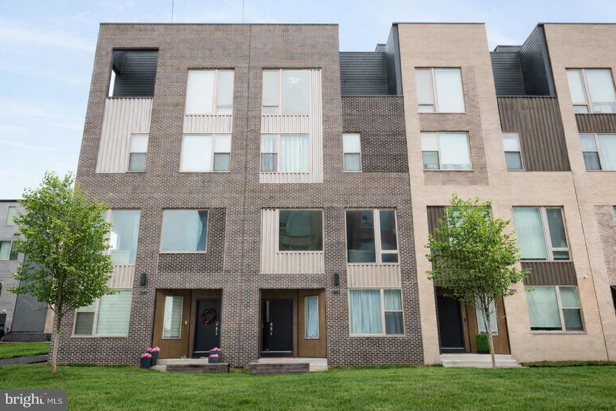 Welcome to this exceptional 3,800 sq ft elevator townhome in the highly desirable Northbank community, perfectly positioned along the Delaware River. This beautifully appointed 4-bedroom, 3 full and 2 half-bath residence offers the ideal blend of luxury, functionality, and waterfront living.

The entry level features a spacious office, powder room, ample storage, and interior access to the oversized two-car garage. Upstairs, the main living level impresses with 10’ ceilings, oversized 8’ windows, and an open-concept layout ideal for entertaining. The gourmet kitchen includes stainless steel appliances, quartz countertops, abundant cabinetry, and a dining area with adjacent powder room. Exterior photos have been altered using AI to remove snow and add spring greenery.

The bedroom level offers three generously sized bedrooms — two sharing a hall bath and one with a private ensuite — plus a full laundry room with overhead cabinetry.

The upper level is dedicated to the luxurious owner’s suite featuring a custom walk-in closet and spa-like bath with soaking tub, separate shower, and double vanity. A wet bar and flexible bonus space (perfect for lounge, gym, or office) opens to a private balcony.

The rooftop deck with Trex decking showcases sweeping Delaware River views — north to Graffiti Pier, south to the Ben Franklin Bridge, and east to Petty Island.

Additional features include brick front, Pella windows, Energy Star certification, two-zone HVAC, smart home wiring, and approximately 8 years remaining on the tax abatement.

Northbank residents enjoy community parks and walking trails, all within close proximity to shopping, dining, and major highways.

Turnkey waterfront living with space, views, and convenience.