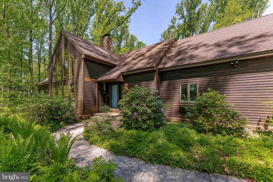 Welcome to 147 Highland Road, a 3-bedroom, 2.5-bath contemporary single-family home in Schwenksville, located in the award-winning Spring-Ford School District. Set on 3.5 private, wooded acres, this property offers space, privacy, and a peaceful natural setting. Inside, the foyer features hardwood floors and a vaulted ceiling, opening to a dramatic living room with exposed beams, a floor-to-ceiling stone wood-burning fireplace, and a wall of windows that fills the space with natural light. The newly renovated kitchen includes hardwood flooring, granite countertops, a center island with seating, a double sink, and ceiling beams that carry the home’s architectural style throughout. The dining room offers hardwood floors, exposed beams, and double sliding doors that lead to the deck, creating an easy connection to outdoor living. A nursery with engineered hardwood floors, vaulted ceilings, skylights, and a barn door is connected to the primary bedroom and offers flexible living space. The primary bedroom features luxury vinyl plank flooring and a walk-in closet. The en-suite bathroom includes tile flooring, a step-in shower, soaking tub, and dual vanities. A powder room and laundry room completes the main level. Upstairs, the second bedroom features carpet flooring, a vaulted ceiling, and a ceiling fan. A loft area with skylights provides additional flexible space for a home office or sitting area. The full bathroom on this level includes luxury vinyl plank flooring, a vaulted ceiling, skylight, and a tub and shower combination. The third bedroom offers carpet flooring, a vaulted ceiling, ceiling fan, and a walk-in closet. The finished lower level expands the living space with a family room, a bonus room ideal for a playroom or home theater, and a rec room with direct access to the backyard. The outdoor setting is designed for both relaxation and entertaining, featuring a heated in-ground pool with a spa and expansive yard space surrounded by mature trees for privacy. Additional features include a geothermal heating system for energy efficiency. Conveniently located near Limerick Community Park, local shopping, grocery stores, and restaurants, this home offers a balance of privacy and accessibility. Don’t miss the opportunity to make 147 Highland Road your private retreat.