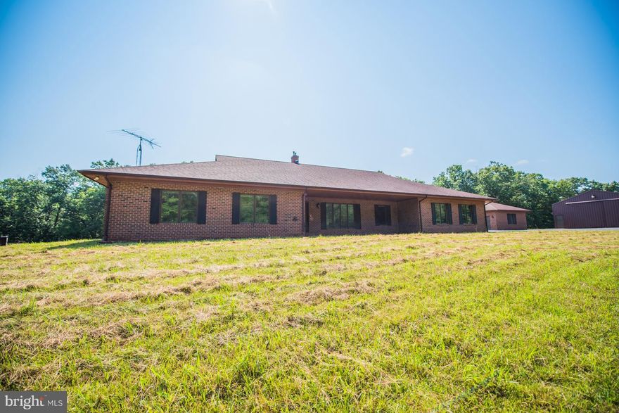 Beautiful Brick Rambler, sitting on almost 44 acres of hardwoods, with 7 acres of pasture, nice panoramic view. Home includes- Living Room, Family Room / Fireplace, Sun Room, Country Kitchen / Cherry Cabinets, Hardwood Floors, New Geothermal Heating / Air, unfinished basement, 2 car attached garage. Single car detached garage, Large garage / workshop. Convenient  location near Berkeley Springs WV.