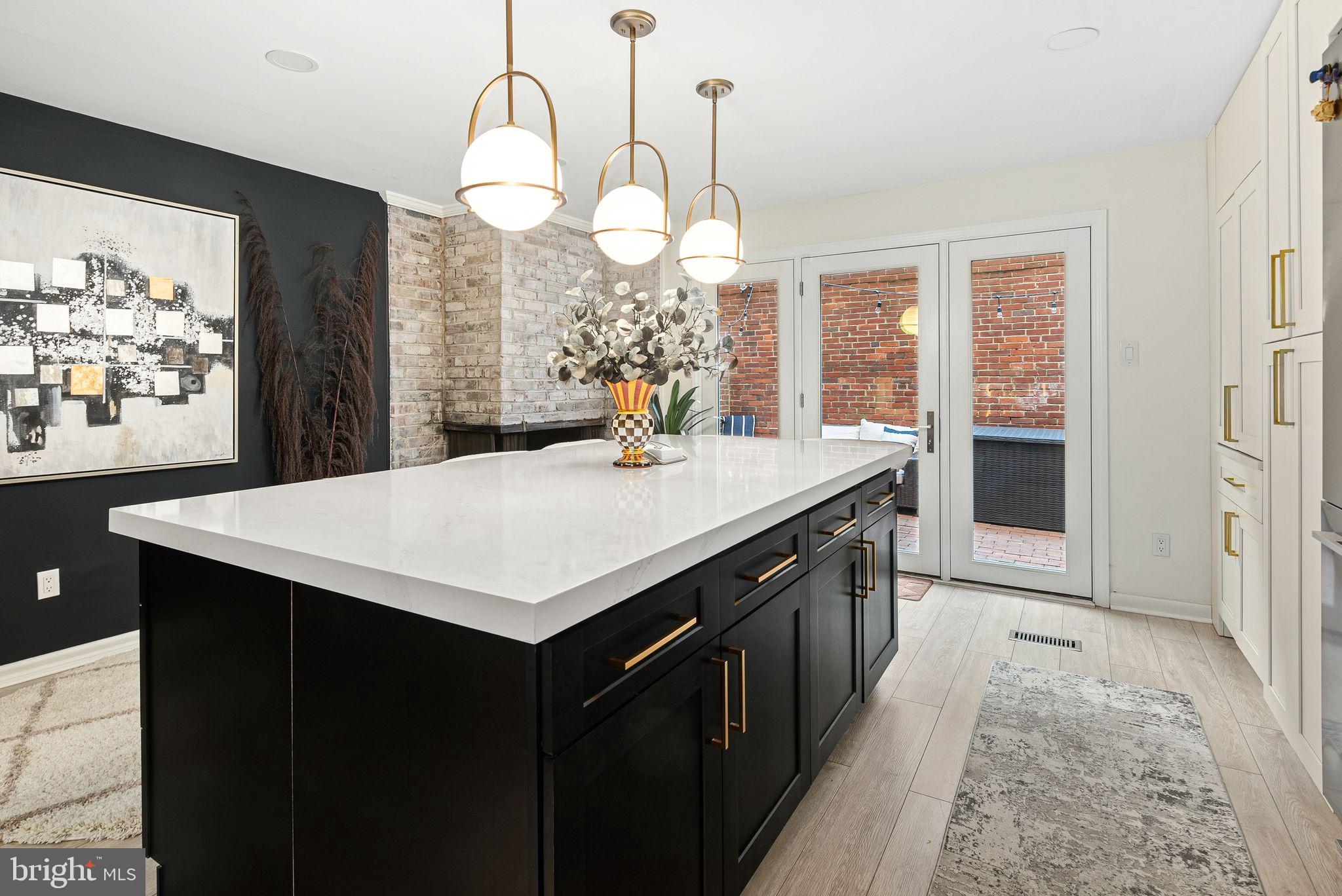 Welcome to 418 S 11th Street, a stunning split-level residence where timeless elegance meets modern luxury. Spanning three beautifully designed levels, this 3-bedroom, 2.5-bathroom home boasts an impeccable layout, high-end finishes, and abundant natural light. Thoughtfully curated details—from rich hardwood floors to striking gold accents—elevate every space, creating an atmosphere of effortless sophistication.
The expansive living room sets the tone with oversized windows that flood the space with sunlight and offer picturesque views. The adjacent dining area is defined by chic black-and-white tiled floors, leading seamlessly into the showstopping eat-in kitchen. Here, a grand white quartz dining island, gold-accented cabinetry, a farmhouse sink, and premium stainless steel appliances—including a Fisher & Paykel refrigerator and a gas range with a custom hood—combine to create a culinary masterpiece. A hidden coffee bar/nook adds a touch of convenience and luxury. Sliding Pella glass doors off the kitchen open to a private patio, perfect for entertaining guests or enjoying a quiet retreat.
The second level offers two generously sized bedrooms, each with ample closet space and abundant natural light. A stylish full bathroom with a glass-enclosed shower and pedestal sink completes this floor.
The entire third level is dedicated to the luxurious primary suite, a private retreat featuring two expansive closets, gorgeous hardwood floors, a custom dressing area with built-in storage, and a built-in floor safe for added security. Wake up to breathtaking views of the Philadelphia skyline from your bedroom. The en-suite bathroom is a true spa-like sanctuary, wrapped in marble with a stunning arched entryway, a dual-sink vanity with ample storage, a large glass-enclosed rainfall shower, and a freestanding soaking tub positioned beneath a window.
The lower level, enhanced by the home’s unique split-level design, houses the laundry room, additional storage, and a whole-house water filtration system while maintaining an open, airy feel. A mechanical room is conveniently located at the front of the property.
Located in the heart of Washington Square West, this home is just steps from Seger Park—with its playground, dog park, and pickleball/tennis courts—and moments from Whole Foods, ACME, and some of the city's finest restaurants and cafés.
One year of pre-paid parking is included with an acceptable offer, making life in the city even more convenient. This is luxury city living at its finest—don’t miss the opportunity to call it home!