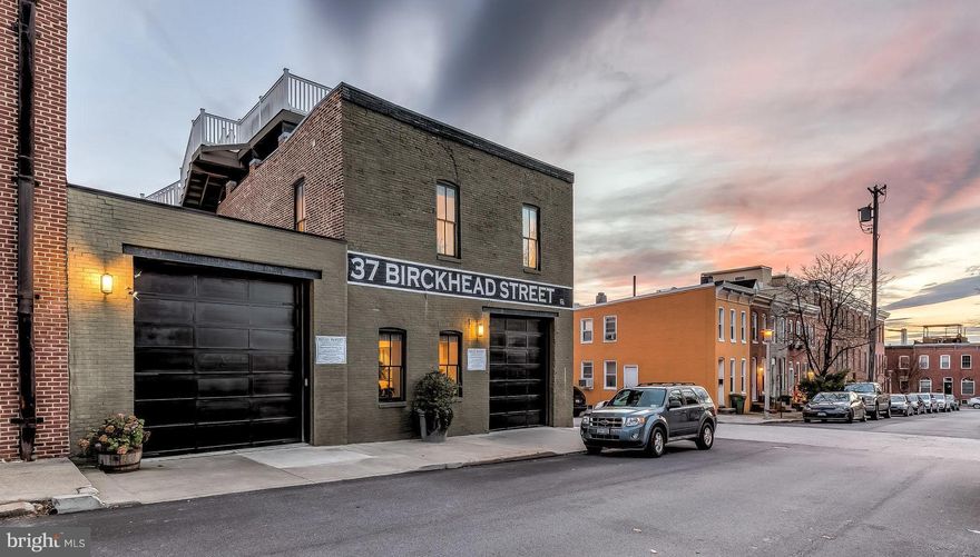 Live Large, Live Luxuriously - 37 Birckhead Street - "Federal Hill's Premiere Residence"  This one-of-a-kind, high-end renovated 1920's warehouse features more than 3,000 square feet of living space with 30'-50' widths, plus an additional 1,200 square feet of outdoor space. Birckhead's features include: 4 bedroom suites, 6 bathrooms, gourmet kitchen, two car garage, private courtyard, two roof top decks, and wet bar.  Enjoy the ultimate in urban living without condo fees, while benefiting from an impressive CHAP Historic Tax Credit that expires July 1, 2024 (Approximately $18,000 in yearly property tax savings). ----- As you enter the home, you will immediately be impressed with the openness of the main level's floor plan which features a 30' wide living space, a massive gourmet kitchen highlighted by Wolf and Sub-Zero appliances, an expansive island that seats 4, and a spacious pantry.  An additional bedroom suite/home office is located on the main level with a private bath. The secluded bluestone courtyard is a sanctuary for relaxing with its own water feature. ----- The grand stairway leads to the second level family room with 9' ceilings, a gas fireplace, and a custom wet bar which includes both a beer & wine fridge plus a dishwasher. The master bedroom has 11' ceilings, detailed molding, a walk-in closet with personalized Poliform cabinetry, and a spa-like bathroom with double vanities, over-sized shower featuring multiple body jets and a rain shower head. Also on this level, 2 more bedroom suites that offer exposed brick, detailed moldings, private baths, and personalized closet systems. ----- Outdoor space is in abundance with multiple roof decks. The lower deck offers room for grilling and private dinners. As you walk up the stairs to the city-lined view you will be in awe! Entertain on the 23' x 24' massive deck while your guests enjoy playing on the all-weather pool table. ----- To see more of the home check out the 3D Matterport tour.