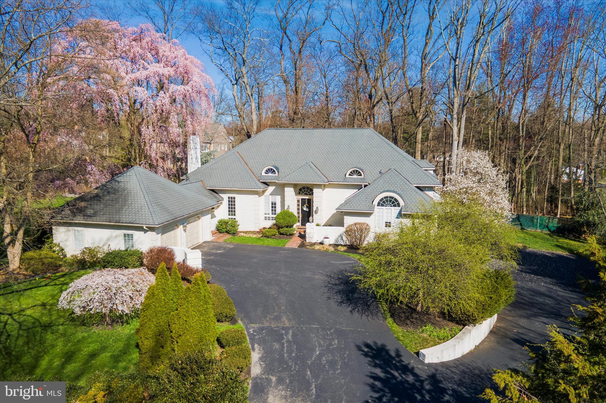Welcome home to this stunning French Colonial, at the end of a cul de sac in the estate section of Haverford.
Walk into the iconic two story foyer with checkered stone flooring and a floating staircase. A marble surround wood burning fireplace welcomes you into the living room. The gray and white cook’s kitchen features a double oven and 5 burners gas cooktop. Wood floors complement the kitchen, breakfast area, and continue into the formal dining room. Off the kitchen, the family room offers vaulted ceilings, arched windows and another wood burning fireplace. A first floor home office with a separate exit features built ins with desk, wood floor, large windows and a vaulted ceiling. The first floor master suite features a private deck and two walk-in closets. The master bath offers marble floors, soaking tub, double sink vanity and separate marble shower room and powder room. Completing the first floor are a wet bar, laundry and mud room which leads to the 2 car garage with extra space for the handy person of the family.
Glass doors lead from the breakfast nook and kitchen to a large and private deck, expanding your entertainment area. The deck overlooks a park-like serene professionally landscaped flat yard, and there is a separate fire pit area.
The second floor offers four spacious bedrooms, two full baths, walk in closets, and an open sitting area which overlooks the first floor family room. There is a second laundry area in the sitting area.
The lower level boasts a large finished recreation room with a second kitchen, full bath, large storage area with a workout space and a third laundry station. There are sliding glass doors with easy access to the outside. An additional 2+ car attached garage can be accessed from the lower level.
This custom home, built by the builder as his own residence is located within walking distance to two train lines. The Village of Haverford, great walking and nature trails, biking routes, Suburban Square stores and Merion Golf Club are all nearby. Award winning schools, or a choice of prestigious private schools are all a short bus ride away. Residents can enjoy the Community Recreational and Environmental Center (CREC) with open space, hiking trails, athletic complex and both indoor and outdoor recreation and athletic facilities.