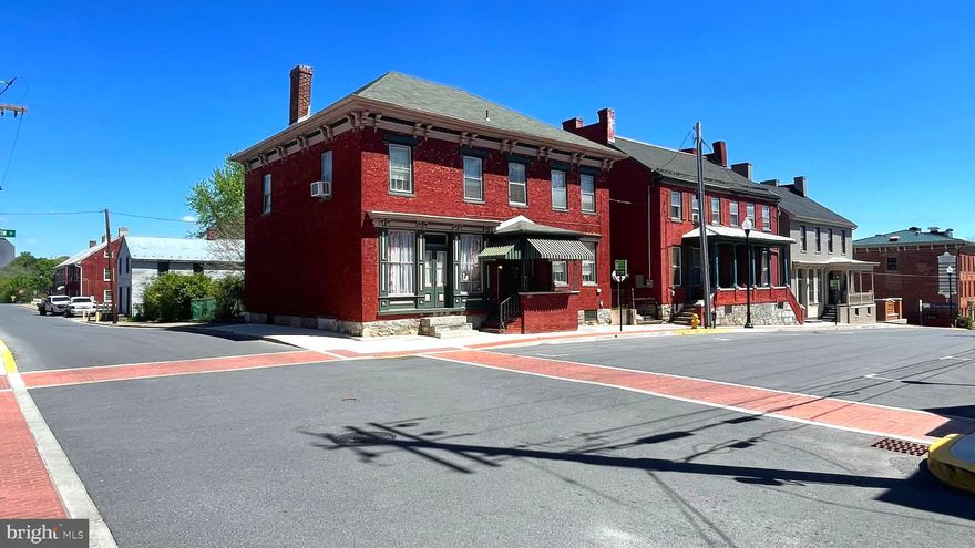 Welcome to 201-203 E. Martin Street!  Built pre-Civil War for B&O Railroad management, this stable and stately home has stood the test of time, all the while watching several of America's most significant historic events unfolded on its doorstep.  This historic property is just steps from the historic B&O roundhouse which saw significant activity and destruction during the Civil War and was the origin of the Great Railroad strike of 1877.  In modern day, you can walk less than a block to the historically restored train station to board the commuter train to Washington, D.C. or take the Amtrak to Chicago, D.C. and all points beyond or in between.  

Interested purchasers of this property shall have an eye for historic architecture and an affinity for historic, unique and special interest real estate.  Fortunately for the enthusiast, this property's historic and architectural integrity remains almost fully intact and is ready for a new owner's touch.  Long ago converted to a mixed use retail/residential property, entering the old store is like stepping back in time -- right down to the existence of the original skeleton key to the store's front door.  Unique to the exterior of the home is the the Greek Revival styling with hip roof and bracketed cornice.  The 6/6 window sashes and 4/4 store windows remain intact, as well as most of the interior moldings and trim.  Cosmetic improvements may be of necessity to some, but the property is usable and functional as-is.  

Inside, there are spacious formal rooms, four bedrooms, a huge attic, a commercial storefront, and a full basement with old cooking kitchen.  While updates over the years have been few, the original elements remain. 

To the rear of the main building, you will find a two-story, wood-sided "creamery" that was also historically a fruit exchange.  Having had very little modification over the past 150 years, this building looks very similar to the way it was when built during the Civil War era.  Beyond the creamery, adjoining an additional 2500sqft lot,  stands a sturdy, wooden barn with three private parking bays and ample storage above.

The coming to market of rare, original properties such as this are an uncommon occurrence.  Potential buyers with an entrepreneurial spirit will be attracted to this property's uniqueness that provides a great slate for work/live, SRO, multi-unit, multi-use or residence.  Zoned for downtown business, close to the commuter train, commuter routes, local industries, local hospitality and nightlife -- the historic  Apollo Theater is on an opposing corner -- the opportunities are only limited by your imagination.  Call now to schedule a showing.