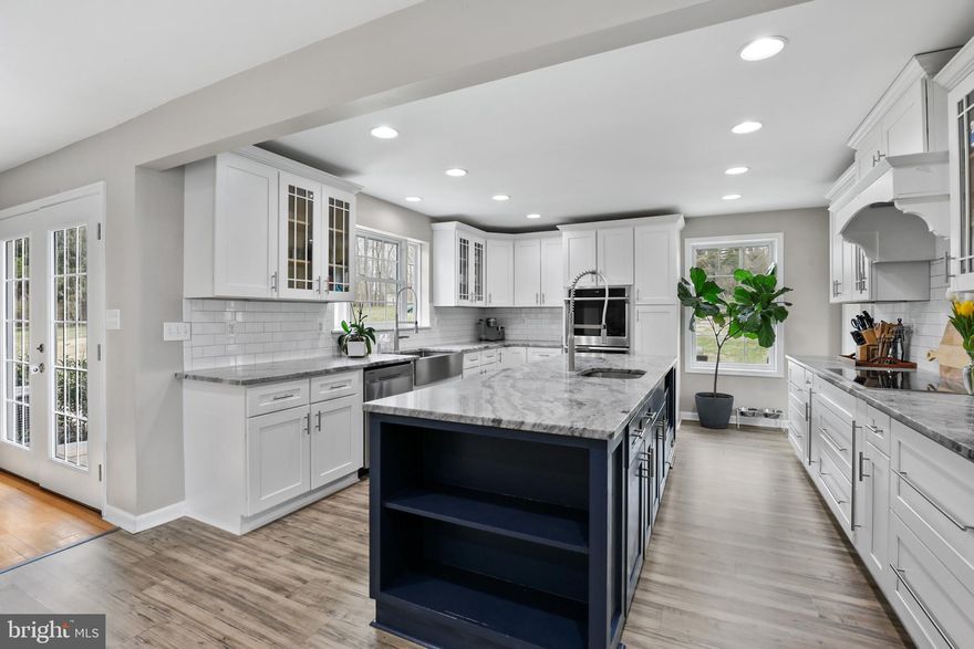 Stunning renovated home on a beautiful one acre lot in Fallston! Large living room with hardwood floors, chair rail and crown molding. Family room with stack stone wood burning fireplace with raised hearth. Family room opens to a gourmet kitchen addition with white shaker cabinets, quartz counters, double wall oven, induction cooktop with exhaust hood and island with seating. Mud/Laundry room off kitchen with Samsung washer/dryer. Primary bedroom with en suite bath. Two additional bedrooms and hall bath on entry level. Fully finished lower level with rec room, bedroom, full bath and office. This area could make a great in-law suite. Oversized two car garage. New extensive hardscaping in front and back of home. Paver patio with built-in firepit makes a great space for entertaining. Built-in lighting in rear and front hardscaping. Professional landscaping. Flat back yard with bocce ball area. Whole house solar.  Great location in Fallston! Walking distance to pool, rec center and school. This home is gorgeous!