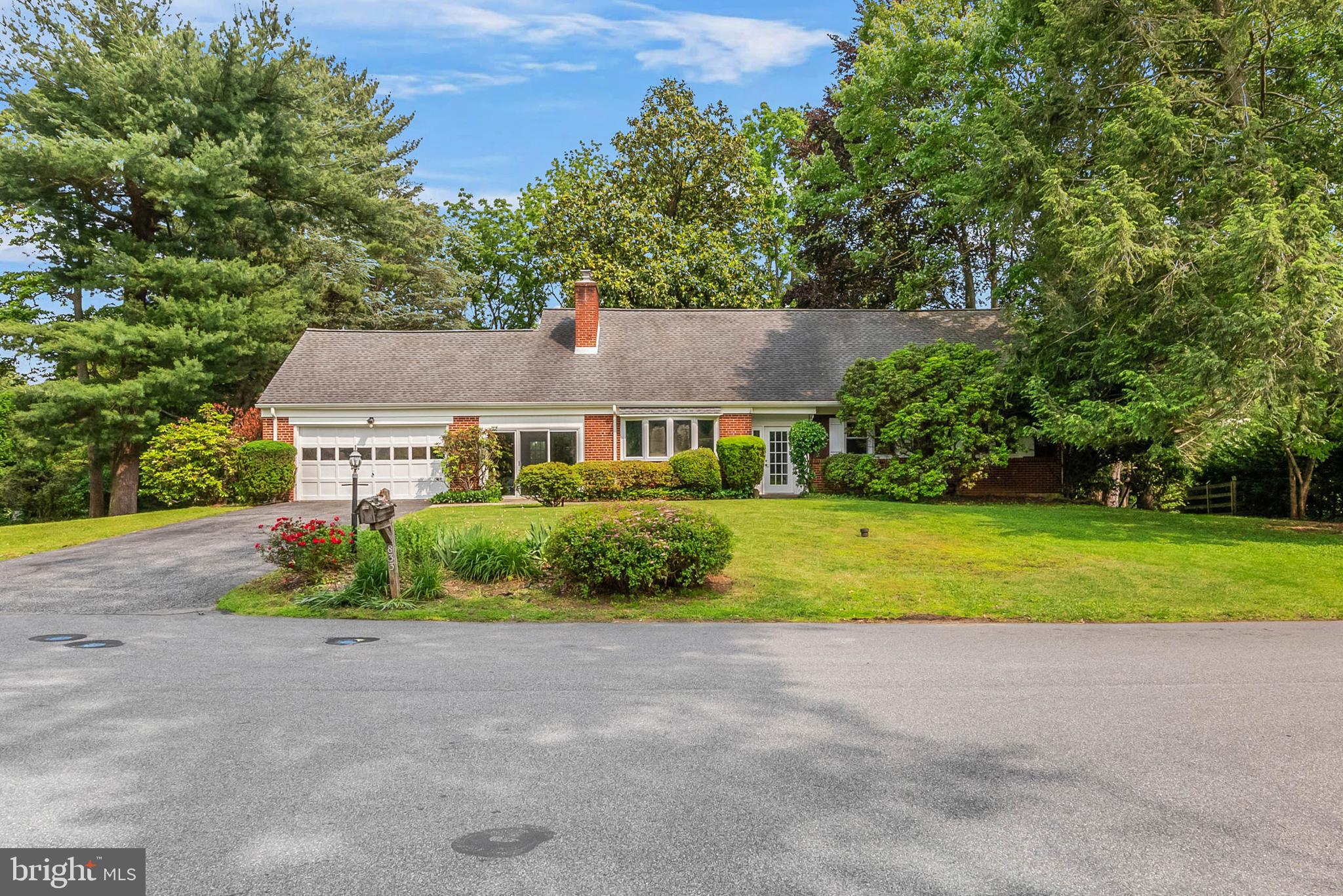 Nestled among the winding, idyllic roads of Media's quiet Parkridge neighborhood, you'll find 833 Parkridge Dr. This 3,400+ sqft, 2-story home has 5 bedrooms, 3.5 bathrooms, an expansive finished basement, a sprawling backyard, a 2-car garage, and placement within the award-winning Wallingford-Swarthmore School District. Out front, you're greeted by picture-perfect curb appeal comprised of manicured shrubbery, a lush lawn, mature trees, and a classic brick facade. Inside, a vestibule leads to the carpeted main level. To the left is a huge living room anchored by a fireplace and bright bay windows. Another wall of windows provides views of the backyard from the dining room. From here, there's access to a den that connects to the garage. At the center of the main level is a kitchen fitted with generous cabinet and counter space and a full suite of stainless steel appliances. Down the hall is a spacious primary bedroom suite with an attached full bathroom, an additional pair of bedrooms, and a full hall bathroom. Upstairs hardwood floors extend throughout two more large bedrooms, each with great closet space. A full bathroom and an attic running the width of the home complete this level. Lots more living space is offered in the huge finished basement, perfect for a media room. There's also a bar, a laundry room, a powder room, a second flex space, and a storage room. In addition to everything inside, you can spend good weather days enjoying barbecues, gardening, and outdoor play in the huge backyard. 833 Parkridge Dr's utilities include central a/c, oil forced-air heat (underground tank), electric hot water and a whole house generator (propane). This sought-after location, just off Beatty Rd, is close to top restaurants, friendly shops, popular markets, and community events along E Baltimore Pk and lively State St in Downtown Media. There's also easy access to Providence Rd, I-476, Rt-1, and Center City Philadelphia via the Regional Rail. Schedule your tour today! The square footage number includes the finished basement.