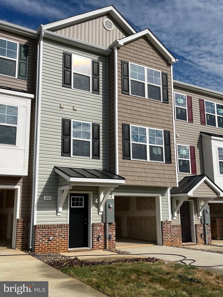 New Town Homes under construction in The Communities of Burwell featuring 1935 sqft of living space. Home has bump outs in main level family room and upper level secondary bedroom, spacious open floor plan, 4 bedrooms/ 3.5 baths, Kitchen with granite countertops, separate island and island bar to family room, stainless steel appliances, and luxury vinyl plank flooring throughout the main level. The upper level primary bedroom has vaulted ceilings, walk in closet, and full bath with tile shower and glass door. The lower level offers 4th bedroom and full bath. Exterior brick on front, 1-car garage with auto opener, and concrete driveway included. **interior photos are similar construction**