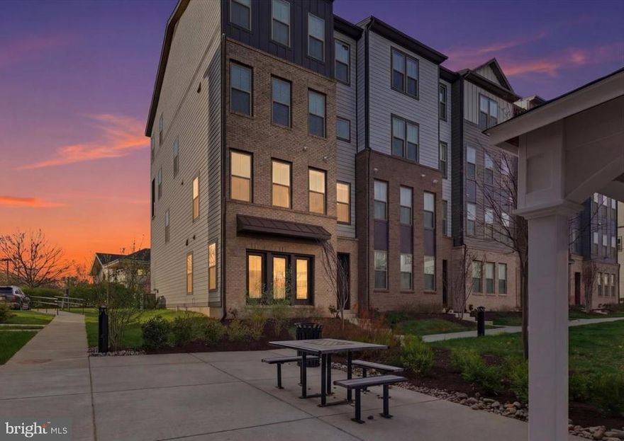 Discover elevated living at 46037 Woodpecker Square in Potomac Falls — a beautifully designed end-unit townhouse-style condo that blends modern comfort, natural light, and everyday convenience. This nearly new 3-bedroom, 2.5-bath home offers a bright and airy layout, enhanced by its premium end-of-row location with windows on multiple sides, filling the space with abundant natural light.

The open-concept main level features wide-plank flooring, expansive windows, and a stylish gourmet kitchen complete with quartz countertops, stainless steel appliances, and a large center island that seamlessly connects the living and dining areas—perfect for both relaxing and entertaining. Direct access to the attached garage adds ease to daily living, along with extra storage space.

Upstairs, the spacious primary suite offers a walk-in closet and a spa-inspired bathroom with dual vanities and upgraded finishes. Two additional bedrooms, a full bath, and a conveniently located upper-level laundry area complete the thoughtfully designed floor plan.

Located in the desirable Regal Chase community, this home puts you close to everything—shopping, dining, coffee spots, and major commuter routes. With quick access to Route 7, Route 28, and Dulles International Airport, commuting is simple while still enjoying a peaceful, well-maintained neighborhood setting.

Offering exceptional value, low-maintenance living, and modern construction, this move-in-ready home is ideal for first-time buyers, investors, or anyone seeking a turnkey lifestyle in the heart of Potomac Falls.