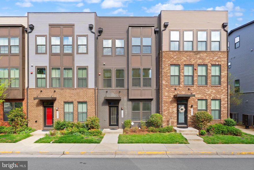 Welcome to this beautifully appointed, and newly painted, four-level townhome in an exceptional community just steps from the Ashburn Metro. Offering nearly 2,900 square feet of thoughtfully designed living space, this move-in-ready home features 4 bedrooms, 3 full baths, and 2 half baths, blending comfort, style, and convenience.

The entry level showcases a spacious open recreation room with brand new hardwood flooring—perfect for a secondary living space, home office, or gym—along with a convenient half bath and access to the attached two-car garage. Elegant oak stairs with metal balusters lead you to the main living level.

Upstairs, the heart of the home features a gourmet kitchen complete with a large granite island, cooktop, double oven, stylish backsplash, and rich dark cabinetry. The open-concept layout flows seamlessly to a covered balcony—ideal for morning coffee or evening relaxation. This level is designed for both everyday living and entertaining.

The bedroom level includes a dedicated laundry room for added convenience. The spacious primary suite offers a large walk-in closet and a luxurious en-suite bath with dual granite vanities, upgraded tile flooring, and a beautifully tiled shower. Secondary bedrooms are well-sized, and the hall bath also features granite countertops.

The top level provides a private retreat with an additional bedroom and full bath, an open recreation room, along with access to a stunning rooftop terrace—perfect for entertaining or enjoying peaceful outdoor living.

Ideally located with easy access to the Dulles Greenway and just minutes to Dulles International Airport, this home is also close to Loudoun Station, offering a variety of restaurants, shops, and a movie theater, as well as Broadlands Marketplace. Residents enjoy outstanding community amenities including lawn care, multiple parks, playgrounds, a dog park, amphitheater, pavilion, swimming pool, BBQ grills, clubhouse, fitness center, and scenic walking and jogging trails.

Experience the perfect blend of modern living and unbeatable location!