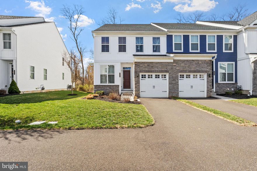 Welcome to 407 Wynstone Court – a stunning end-unit home nestled in the highly desirable Walnut Creek community at Montgomery, within the North Penn School District. Built in 2019, this beautifully maintained property is located on a tranquil block, offering extra privacy and peace due to its end-unit location.

As you enter the home, you are greeted by a bright and inviting foyer that leads to a spacious office, ideal for work or relaxation. The open-concept main floor is perfect for modern living and entertaining, featuring soaring nine-foot ceilings and an expansive great room that blends the family and dining areas seamlessly. The chef’s kitchen is truly the heart of the home, boasting upgraded granite countertops, elegant cabinetry, a stylish tile backsplash, stainless steel appliances, and a professional-grade range hood. A sliding door off the kitchen opens to a generously-sized deck, perfect for outdoor gatherings, offering privacy and stunning views of the wooded open space behind the home.

The main floor also includes a beautifully appointed powder bathroom and a large closet for added convenience.

Upstairs, the spacious primary suite features two large windows that flood the room with natural light, a walk-in closet, and a luxurious ensuite bathroom with an upgraded marble vanity, an expansive shower with a glass enclosure, tile surround, and upgraded tile flooring. Two additional large bedrooms, each with ample closet space, share a well-appointed hall bathroom. All bedrooms come with upgraded carpeting and ceiling fans. A second-floor laundry room, conveniently located, includes a laundry tub, an overflow drain system, and a hall linen closet.

The home also offers a spacious, unfinished basement, providing abundant storage space or the opportunity to finish the space to suit your needs.

Parking is never a concern with a large front-entry garage equipped with a garage door opener, plus a spacious driveway offering additional parking options.

The backyard offers a tranquil, wooded view that enhances the home’s sense of privacy and serenity. Being an end unit, you’ll enjoy added space and a feeling of openness, along with no neighbors on one side. The community provides private walking paths and trails that wind through protected wooded areas. The HOA fee covers snow removal (including sidewalks and driveways), trash removal, and lawn care, ensuring a low-maintenance lifestyle.

Conveniently located with easy access to Route 309, the Colmar SEPTA train station, and the PA Turnpike, this home offers both comfort and convenience. Don’t miss the opportunity to make this beautiful end-unit home yours!