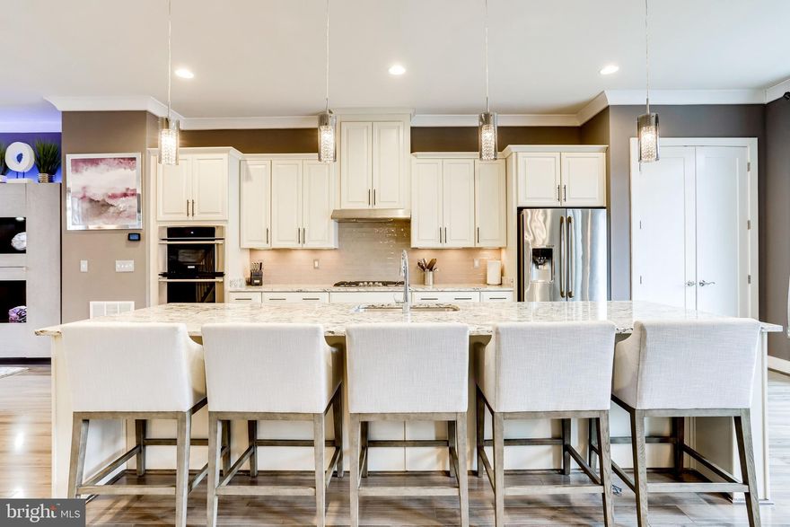 Offer submission deadline Sunday 1/31 10:00am. Welcome to One Loudoun - your urban oasis tucked away from the big city! This stunning townhouse offers incredible updates and a luxury contemporary floor plan. This Kensington floor plan is one of Stanley Martin's largest floor plans featuring 10 foot ceilings, and has 4 levels which includes 3 bedrooms, 2 full bathrooms, 3 half bathrooms,  additional living room on lower level, an upper level loft/bonus space, a deck, and a 4th floor terrace. The main level  gourmet kitchen features granite counters, upgraded cabinets with lighting, upgraded tile backsplash, high end kitchen appliances, including a 5-range gas stove, a 12 foot island with updated fixtures and separate dining space that opens to the spacious deck.  Luxury owners suite has 2 closets - one is a walk-in  custom closet designed and built by Closet America, a beautiful master bathroom with double vanity, and large shower with glass door.  Upper level loft/bonus room is perfect for an office or sitting room with half bathroom and access to the rooftop terrace.  Over-sized 2-car garage with a storage room and large driveway for convenience.  Landscaping is included in HOA fee.  Great restaurants and shopping nearby such as Uncle Julio's, Matchbox, Bar Louie & Barnes and Noble OR see a movie at The Alamo - only steps away from your front door.