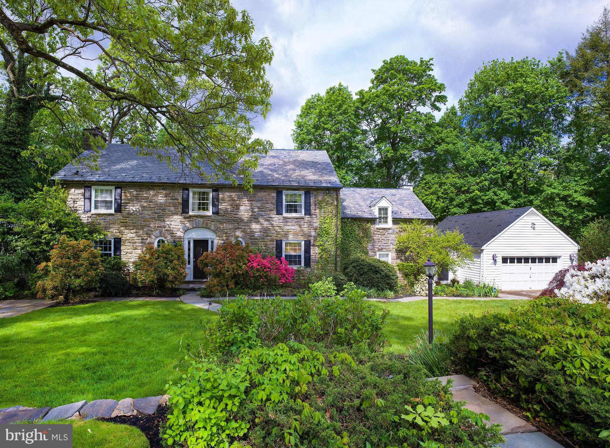 This gracious colonial in Bala Cynwyd welcomes your family home with a prime location on a private road on a quiet cul-de-sac of only eight residences. Its elegant exterior with slate roof makes a great first impression, while beautiful grounds and spacious patios provide a peaceful setting for outdoor enjoyment and entertaining. Inside is just as inviting, featuring generously-sized rooms, hardwood floors, large windows, glass French doors, and quality millwork. Off the entry foyer sits a convenient powder room, handsome office for working remotely, and elegant living room with a wood-burning fireplace to gather around with loved ones or guests. From here you can read, relax and catch some rays in the enclosed sunroom enveloped by windows looking out at nature, or share formal meals together in the airy dining room with tasteful corner built-ins. Nearby is a light-filled open kitchen appointed with granite counters, a marble island with secondary sink, stainless steel appliances, and a sky-lit breakfast area for snacks and morning coffee. A step-down open family room adjoins, offering a comfortable, relaxing setting with a gas fireplace and built-ins. Glass-paneled doors from both the kitchen and family room lead to the expansive rear patio for easy indoor-outdoor living. A large mudroom completes this level affording access to the front and back of the house, as well as the oversized 2-car garage. Upstairs, a lovely landing with built-in sitting area greets you and proceeds to the sleeping quarters. The primary bedroom is the highlight of course, with a brand new deck, 2 walk-in closets, and en-suite bath with 2 sinks and refreshing rain head shower. An additional bedroom with walk-in closet, 2 more bedroom suites, and a laundry room with cedar closet also occupy the 2nd level. Topping the homes appeal is abundant closet space, a partially finished basement with powder room, central air, security system, and prime location in the award-winning Lower Merion School District with close proximity to Center City.