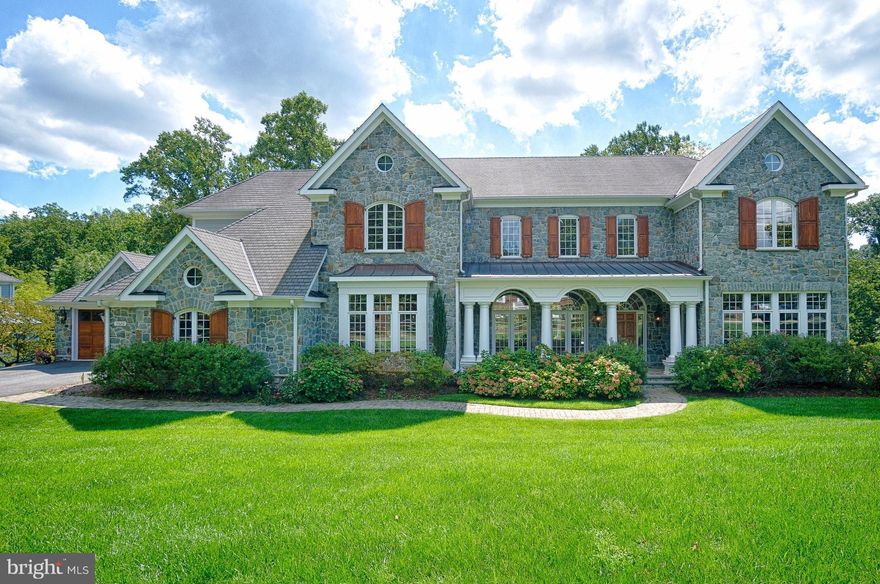 Portrayed gracefully w/ a roomy & smart design this grand custom designed stone-front home is ready to welcome new owners! Tall ceilings custom designed trim thru out floor to ceiling windows  Gourmet Kitchen Lush Dining private veranda Lavish owners suite w/steam shower. Lower level is beyond compare!  ELEVATOR to all levels/Car enthusiasts:4 CAR GARAGE!