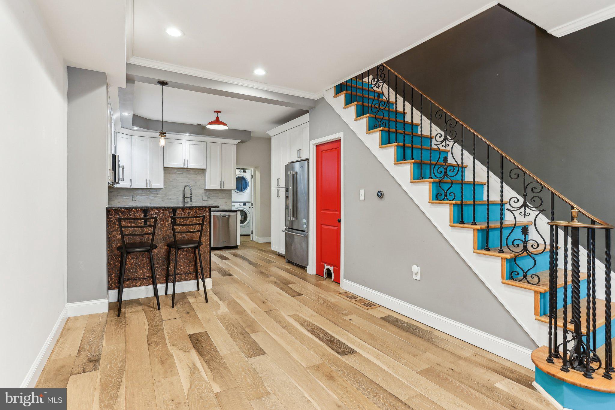 Don't miss this meticulously maintained rowhome bursting with modern upgrades and tucked away on a desirable street close to public transit and Passayunk Avenue with easy access to shops and restaurants. This lovely home boasts newly stained exterior brick and a designer front door. Upon entering you'll find a wide open floorplan with hardwood flooring, a spacious living area and an upgraded kitchen with granite countertops, ample cabinet space with soft-close drawers, plus a charming breakfast bar with a custom copper penny accent wall. Off of the kitchen is the convenient main floor full bathroom complete with a stacked front-loading washer and dryer. The upper floor offers two spacious bedrooms and a full upgraded bathroom with a skylight allowing for great natural light. This home is fully-equipped with Smart technology, allowing everything to be controlled with your phone including the Nest Thermostat, keyless entry, lighting, smoke detectors and security cameras. This is the one!