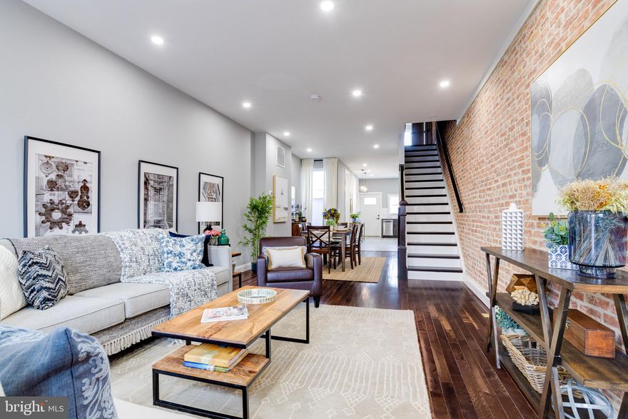 Located in Patterson Place/North Butchers Hill/ just .4 miles from John Hopkins Hospital & 2.5 miles to Hopkins Bayview.  This almost new property was fully renovated in 2022. This light-filled and fully updated 3br/3ba row-house features: tall ceilings, hardwood floors, exposed brick, lot of natural light, upper-level laundry, fence rear patio, a large spacious basement den/flex room with an electric fireplace. The main level features a spacious living and dining area with a stylish kitchen with dark cabinets, tile backsplash,  quartz countertops, stainless steel appliances and tons of natural light. The window over the sink looks out at the fenced rear patio which could easily be a parking pad again if the fence is removed. The upper level features 3 bedrooms (each room can fit a queen bed), 2 full bathrooms, and laundry.  The primary bedroom on the upper level features an ensuite bathroom with dual sinks and dual shower heads. The basement den/flex room is spacious with an electric fireplace, a full bathroom, and an unfinished storage area w/ a 2nd set of laundry hookups. Property has been freshly painted. Blinds, Rods, Curtains, & TV Mounts Convey. Come Take A Look. 

Local Attractions: Go Ravens(3.0 miles)! Go Orioles (2.4 miles)! Just .3 miles (5 blocks) to Patterson Park, 1.6 miles to Canton Square, 1.1. miles to Broadway Market, .6 miles to Northeast Market, & 2.7 Miles to Baltimore Penn Station