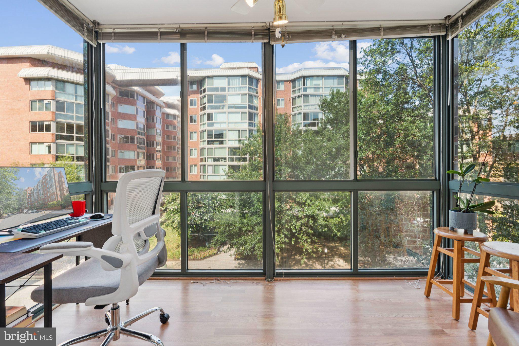 Bright and spacious 1 bedroom/1 bath condo featuring a BONUS glass-enclosed SUNROOM—perfect for a cozy reading nook or stylish home office. Just two blocks from the BALLSTON METRO STATION, this prime location offers unbeatable access to shopping, dining, and everyday conveniences. Included with the unit are a GARAGE PARKING SPACE and a STORAGE UNIT, providing both comfort and functionality in the heart of Ballston.
Unit 406 has 675 SQFT of finished living space, PLUS the enclosed sunroom. The entry foyer includes tile flooring and a large coat closet. The kitchen overlooks the living area and offers granite countertops, stainless steel appliances, and a gas range.
The bedroom features custom blinds, a large walk-in closet, and a second oversized reach-in closet, offering exceptional storage. The full bath features a linen closet, a vanity with a medicine cabinet, and a tub/shower combination. Additional highlights include a WASHER/DRYER (2019) and a newer microwave (2024).
The building is pet-friendly and professionally managed with an on-site manager. Community amenities include an OUTDOOR SWIMMING POOL, grill-equipped terrace, and bike racks. Tucked away on a quiet, dead-end street with no through traffic, yet just steps to everything BALLSTON has to offer, this home truly has it all.