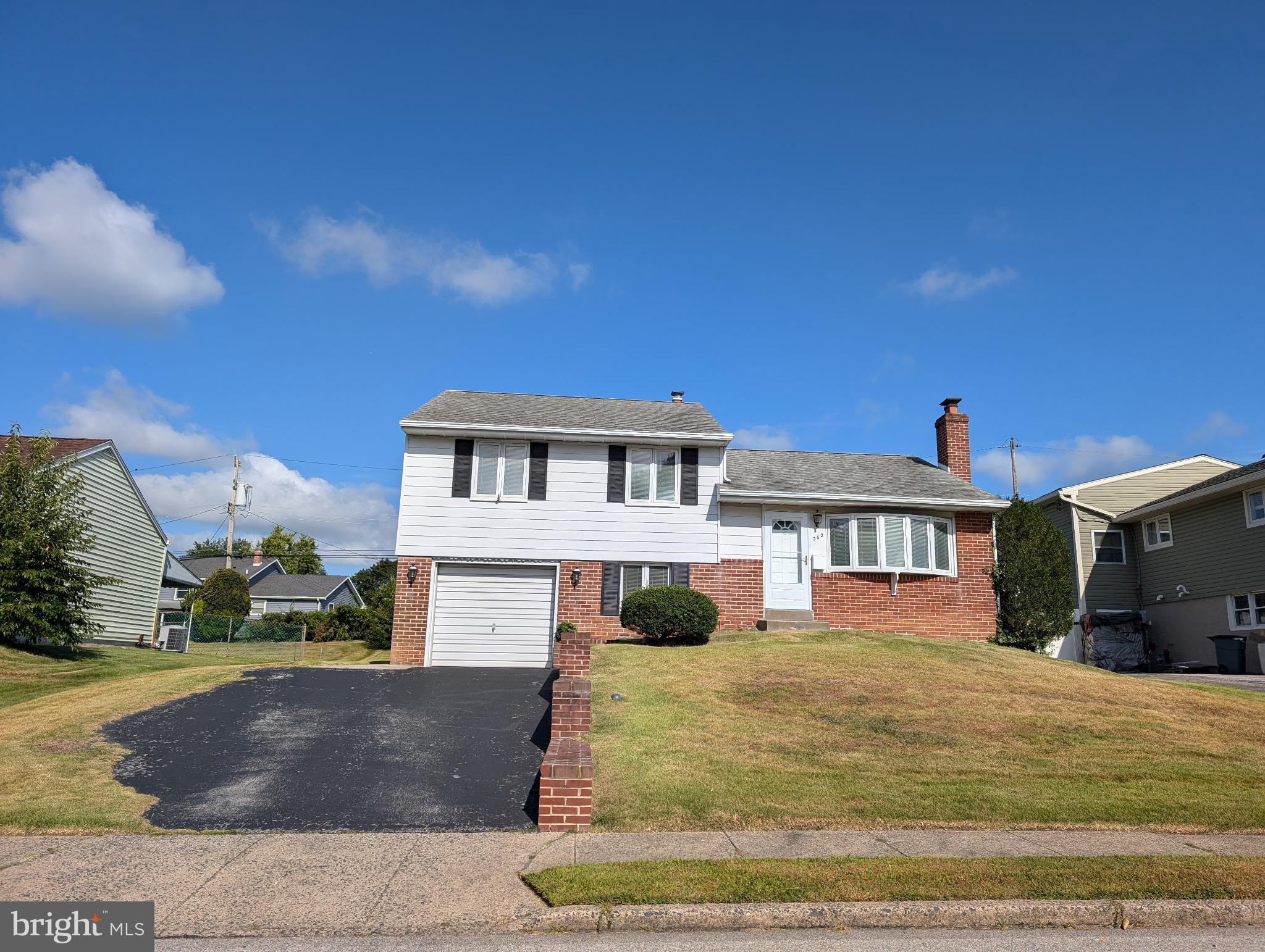 This well loved ONE Owner Family home in Lawrence Park is ready for you to make it your own! The bright living room surprises you with a brick wall fireplace (built in the 1970s) features a stone mantle with matching hearth and built in brick curio shelves. The dining room has a sliding door to the back yard with a deck ( needs replacement). There are wood floors under the living room and dining room carpets. The Kitchen is ready for your ideas and leads downstairs to the family room with wall cabinets and a large crawl space for storage. The utility room with washer and dryer , powder room and laundry tub has access to the back yard. The second floor's three bedrooms with wood floors share a ceramic tile bath. Then to top it off there is walk up attic. The one car garage is waiting for YOUR car! The peaceful backyard awaits with a cement garden bench to enjoy. All this and minutes to the Blue Route, major highways ,restaurants and shopping. Owner has not used the fireplace in over 20 years