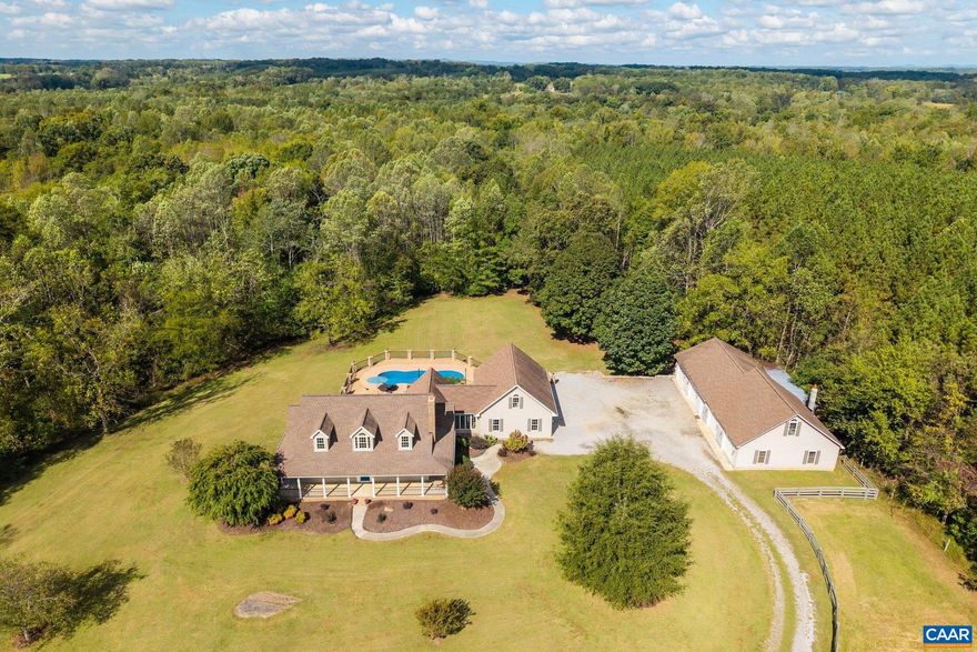 Set on 10 tranquil acres along White Oak Mountain Ridge, this refined country home showcases exceptional craftsmanship and warmth throughout. Custom woodwork, coffered ceilings, a mahogany and walnut inlay dining floor and solid poplar wainscoting highlight the home?s attention to detail. The light-filled breezeway, finished in rainforest marble with hand-glazed accents and trim, connects the main living areas with effortless elegance. The kitchen features custom solid mahogany and walnut cabinetry, granite countertops, Sub-Zero refrigerator, Wolf range, Miele dishwasher, and solid wood floors, while hickory floors flow through both bedrooms. The lower level includes a wood-paneled ceiling, granite bar, and a wine cellar built in knotty alder with a solid wood door antiqued to look like a castle door?perfect for entertaining. Outdoor living is equally inviting, with wrought-iron accents, a saltwater pool with brand new system, koi pond, and mature walnut, crepe myrtle, and pin oak trees framing the property. A separate four-car garage complements the attached three-car, completing this beautifully designed retreat surrounded by nature. Additional Acreage Available!,Cherry Cabinets,Granite Counter,Maple Cabinets,Fireplace in Basement,Fireplace in Great Room