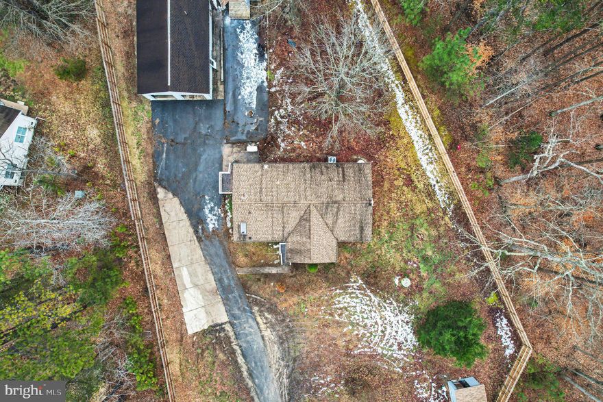 Professional photos to come on 2/24/26. Turn this EXCEPTIONAL PROPERTY back into the home that it deserves. The property was neglected for several months this fall and winter and the family is still in the process of cleaning it up but don't let that stop you from checking it out and bringing us an offer! This home will truly be the perfect blend of PRIVACY, functionality, and peaceful country living. Situated on FIVE beautiful ACRES, this one-level home features 3 bedrooms and 2 baths, FULLY FENCED 6-8 foot privacy fencing with gated access, REGULATION BASKETBALL COURT --- A private paved driveway leads to the gate, creating a secluded setting with plenty of space for animals and hobbies --- NO HOA --- The property also includes a detached two-car garage complete with a private unfinished studio apt with plumbing for kitchenette and a full bathroom. MULTIGENERATIONAL living, guests being able to have a private space or the perfect OPPORTUNITY for RENTAL INCOME. --- Conveniently located within easy driving distance to Fredericksburg and Lake Anna, this home combines rural tranquility with nearby amenities. Updates include kitchen and bathrooms 2024, HVAC in 2020, a 30-year roof installed in 2010, and a whole house Generac generator that conveys. Make this property shine for you and your family.