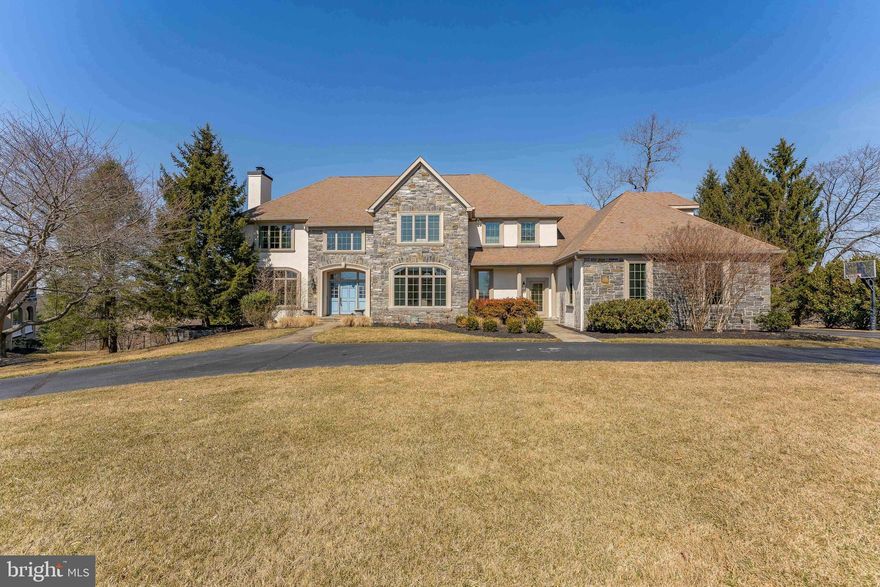 Welcome to 1115 Legacy Lane, a stunning 5-bedroom, 5-full-bathroom, 2-half-bathroom colonial home in the prestigious Longview at Wylie neighborhood of West Chester. This exquisite property features a stone and stucco exterior, a 3-car garage, a large semi-circular driveway, and a sprawling front yard that welcomes you with impressive curb appeal. As you enter, the grand foyer greets you with marble tile floors, recessed lighting, and a staircase leading to the second level. Straight ahead, beautiful French doors open to the back deck, offering serene views of the expansive backyard. To the right of the foyer, the elegant dining room features hardwood floors, a tray ceiling, wainscoting, and a chair rail, creating the perfect atmosphere for formal gatherings. To the left, the living room boasts hardwood floors, a wood-burning fireplace with a slate surround and mantle, and crown molding, adding warmth and character to the space. Double doors with transoms lead from the living room to a private office with hardwood floors, built-in cabinets, and a bay window overlooking the yard—an ideal space for work. A convenient powder room with tile floors and a pedestal is accessed from the foyer. The spacious great room features hardwood floors, a partially vaulted ceiling, a gas fireplace surrounded by stone, and a mantle. This area opens to the kitchen, which is a chef’s dream with hardwood floors, a large island with granite countertops, seating space, pendant lighting, stainless steel appliances, and a pantry. The butler’s pantry offers hardwood floors, a wet bar with a wine fridge, and additional granite countertops. The breakfast nook, with heated slate tile floors, features a sliding door leading to the second deck, perfect for outdoor dining and relaxation. A versatile bonus space off the kitchen with hardwood floors, vaulted ceilings, and a sliding door to the deck offers numerous possibilities.The mudroom includes built-in cabinets and provides easy access to the garage and front walkway, and access to an additional powder room. Upstairs, the primary bedroom is a luxurious retreat with carpet floors, vaulted ceilings, a sitting area, a gas fireplace, a ceiling fan with a light, and two spacious walk-in closets. The spa-like en-suite bathroom offers heated tile floors, vaulted ceilings, a jetted tub, a separate step-in shower, and a double vanity. Adjacent to the primary suite is a convenient laundry room with tile floors and a laundry sink. The second and third bedrooms share a Jack-and-Jill bathroom featuring tile floors and a tub/shower combo. The fourth bedroom has carpet floors, a walk-in closet, and an en-suite bathroom with tile floors and a tub/shower combo. The fifth bedroom boasts carpet floors, vaulted ceilings, a walk-in closet, and an en-suite bathroom with a tub/shower combo. The finished basement offers a perfect space for entertainment. The family/entertainment room has carpet floors, built-in cabinets, and a wet bar with granite countertops. A dining area with heated tile floors and French doors leads to the backyard, providing seamless indoor/outdoor living. The basement also features a fifth full bathroom with tile floors, a stall shower, and a dog-washing station—ideal for your furry friends. A bonus room with carpet floors and an egress window can serve as an additional bedroom or playroom. Completing the lower level is a home gym with rubber floors, perfect for all your fitness equipment. This home offers an abundance of outdoor entertainment space, including a private yard for relaxation or social gatherings. Situated on a quiet cul-de-sac, the property provides both privacy and peace of mind. The garage also features a standard charging outlet for electric vehicles. It’s just a short drive from local shopping, dining, and entertainment, with the Brandywine Battlefield Park and the Brandywine Museum of Art nearby. Don’t miss the opportunity to make 1115 Legacy Lane your dream home!