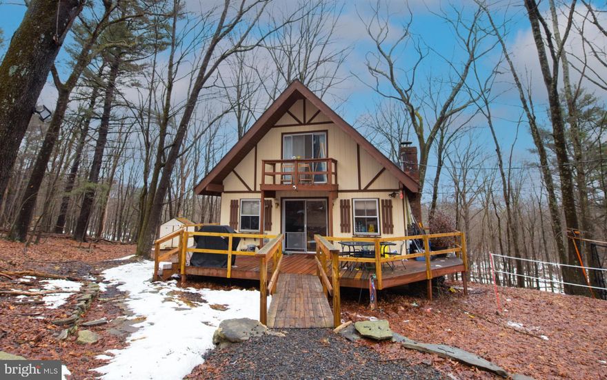 Nestled among the quiet woods of Pocono Mountain Lake Estates, this inviting home blends rustic charm with a peaceful natural setting. Beautiful exposed wood beams and vaulted ceilings add warmth and character throughout the living spaces, creating an open, welcoming atmosphere. Each bedroom features sliding glass doors that invite in natural light while offering private views of the surrounding woods, giving the home a tranquil, retreat-like feel. A wrap-around deck extends the living space outdoors and provides multiple entrances, making it the perfect place to enjoy the fresh mountain air and the beauty of the property. The walkout lower level offers excellent potential for additional living space, giving the next owner an opportunity to customize to suit their vision. Whether you're looking for a full-time residence or a relaxing Pocono escape, this home offers comfort, character, and room to grow.