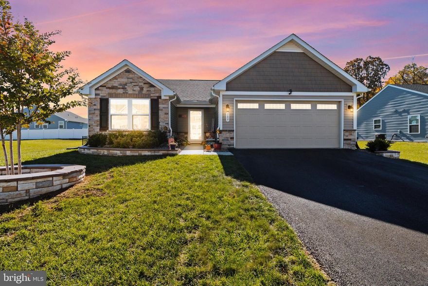 4-year-old rancher home in The Lakes neighborhood. This immaculate 3-bedroom, 2-bath property sits on a slab with no basement stairs to worry about and wider 36-inch doors. The exterior features a stunning stone front and a meticulously landscaped yard with Riverrock. Enjoy outdoor living on a newly added vinyl Trex deck,  fence, and a new shed providing extra storage space.  Inside, you’ll find a modern kitchen with upgraded cabinets, a large island with granite countertops, and tiled backsplash.  A new refrigerator, dishwasher, new water softener, tankless water heater, storm door, and washer &  dryer is only 2 years old.  Tiled bathroom floors with bench in Primary bath.  Wood flooring at the front door entrance, hallway, and kitchen area. Carpet in living room, bedrooms. interior has been freshly painted within the last six months. The garage offers additional storage with ceiling racks, a utility sink, and the driveway was recently resealed.  The Lakes neighborhood provides a dog park, pavilion, and common area near shopping, dining, and easy access to Route 81.