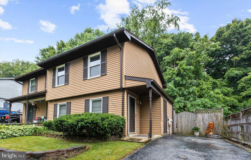 Lovely, well-maintained home in sought out Whispering Woods & Broadneck School District! Large, open spacious kitchen with an extra built in large counter with cabinets and drawers offering lots of extra storage. Attractive wood kitchen cabinets. Glass top stove. Refrigerator with Ice Maker.  Large Master bedroom with walk in closet. New carpet on upper level and stairs.   Newer carpet on main level est. 2 years old.   New flooring in entry foyer. Freshly painted throughout.  New HVAC in 2018. Energy efficient windows. Entertain/Cookout or Relax on newly built patio deck. Beautiful new patio deck slider door. Professionally landscaped in front and back w/ back yard pavers and privacy fence.  Backs to woods. Has driveway and street parking.  Storage Shed in excellent condition. Deck storage box included. Ridge Vent replaced 1 year ago. Only minutes to Shopping, Restaurants, downtown Annapolis, Easy access to Rt 50, Rt 2, 97, Bay Bridge, Washington DC, Baltimore, Fort Meade and more!  Selling As-Is.