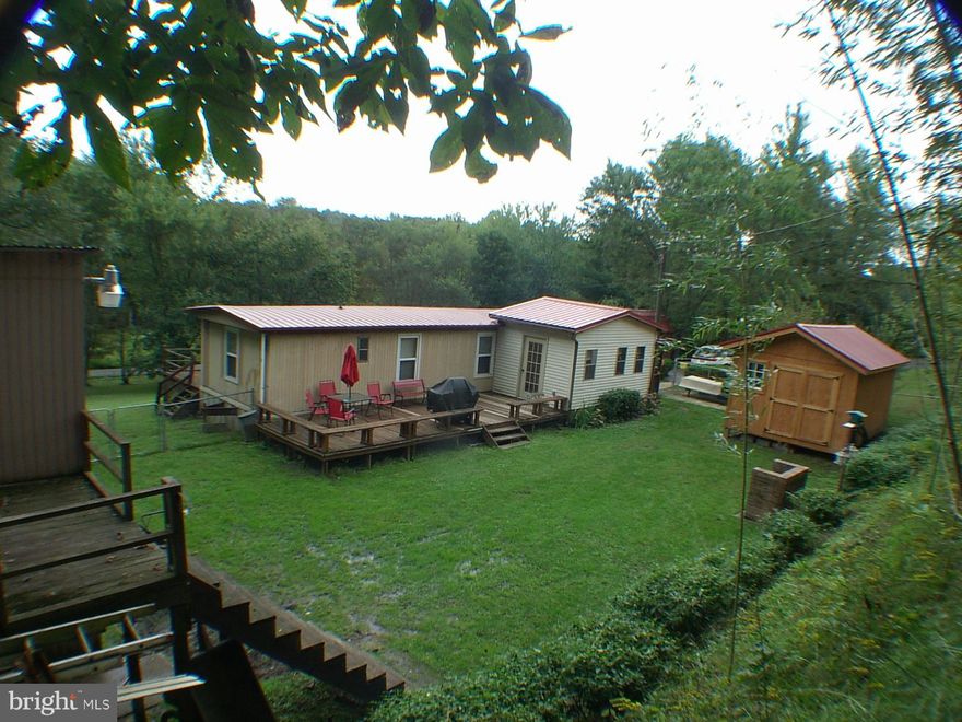 Nice condition 1984 Mobile home with 10X16 nice addition. New roof, thermal windows, new doors, new laminate and vinyl, new hot water heater & well pump.  3 nice sheds 10X16,12X22,16X20, all with electric. 2 large decks to enjoy nature. Fenced yard. Home is total electric and easy to heat and cool.  Maybe some furniture and riding mower. Has water softener sys.
