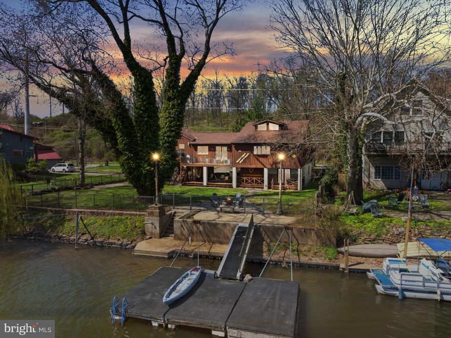 Showings will begin at the Open House Saturday April 11th from 12pm-3pm! Picture a home that delivers the feeling of a year-round getaway, yet keeps you within an easy commute of downtown Philadelphia. 13 W Indian Lane is a rare waterfront opportunity, ideal for anyone who enjoys an active, outdoor lifestyle. Tucked between the Schuylkill River and the Schuylkill River Trail, the property showcases some of Montgomery County’s most beautiful natural views. Set on one of the larger lots in this private enclave, it features 98 feet of direct water frontage and a distinctive design that stands apart from typical homes.

This fully renovated residence offers 4 bedrooms, with a potential 5th, 3 full baths, and 3 half baths, with thoughtful upgrades throughout. Improvements include newer flooring, a redesigned modern kitchen, updated windows, a newer HVAC system, and a generator hookup for added reliability.

Upon arrival, you’ll find an oversized two-car, pull through garage with generous storage and tesla electric charger. The ground level is highly versatile, offering a covered outdoor area that can be used for entertaining, additional parking for up to three vehicles, or simply enjoying the waterfront setting. Inside, a flexible bonus space-complete with a sink and nearby powder room-works perfectly as a game room or gathering area, and is currently being used as a home gym and wellness space.

The main living level is designed to highlight both space and scenery, featuring an open-concept layout. The updated kitchen includes newer appliances, a large walk-in pantry, and flows seamlessly into the dining and living areas. A cozy window seat and an expansive deck with a built-in gas grill make indoor-outdoor living effortless.

This floor also includes two generously sized bedrooms, each with custom walk-in closets and en suite bathrooms, along with a spacious flex room that could function as a fifth bedroom, additional living space, or home office. A spiral staircase leads to a loft-style bedroom with its own powder room-ideal for guests or a creative retreat.

On the opposite side of the home, the primary suite offers a peaceful escape, complete with vaulted ceilings, same-floor laundry, a spacious walk-in closet, and a spa-inspired bathroom featuring double sinks, a walk-in steam shower, bidet, and a private balcony overlooking the river-perfect for morning coffee or evening relaxation.

Outside, enjoy a fenced yard, a private floating dock, and exceptional waterfront living. From here, you’ll have a front-row view of Fourth of July fireworks across the river, along with easy access to boating, kayaking, fishing, or simply taking in the serene surroundings.

Located just steps from the Schuylkill River Trail and minutes from Valley Forge, Westover Golf Club, Jeffersonville Golf Club, as well as shopping, dining, and major routes, this home combines everyday convenience with a true sense of escape. If you’ve been searching for something one-of-a-kind, this property delivers.