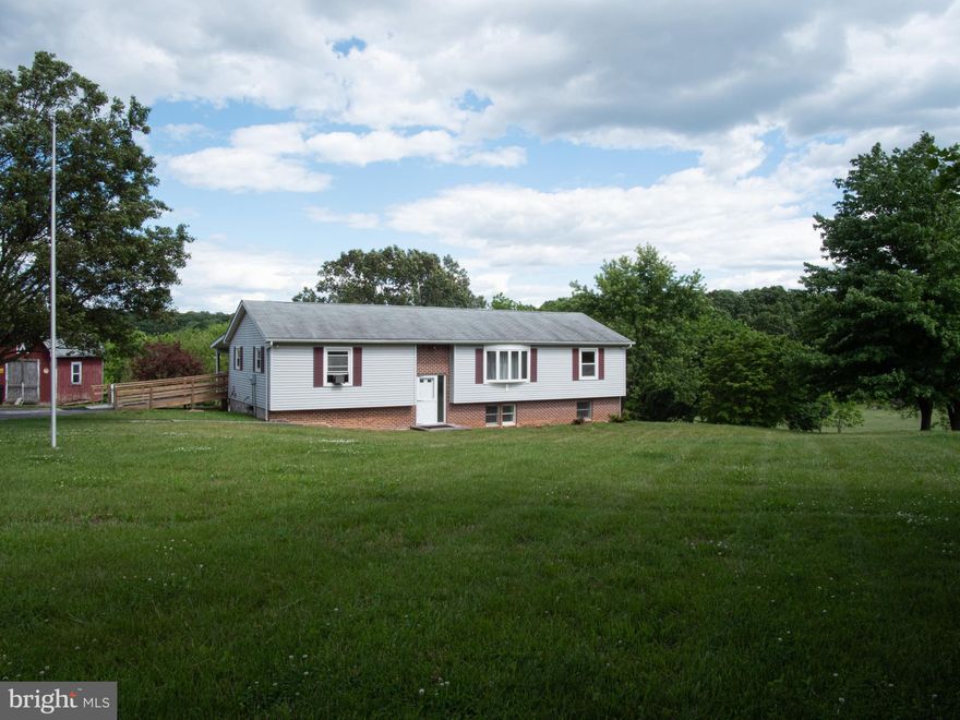 COUNTRY LIVING  ON SPRAWLING 2.41 ACRE FARMETTE THAT IS LESS THAN 1/2 MILE TO MARYLAND LINE.  BUILT IN 1988, NOT 1960 AS IN TAX RECORD!! LARGE, PRIVATE, COVERED BACK DECK IS WAITING FOR YOU TO ENJOY THE STUNNING VIEWS OF PARK-LIKE GROUNDS, TREE-LINE & FARM THAT DATES BACK TO 1700S. SPACIOUS SPLIT FOYER BUILT IN 1988 . MOVE IN AND ADD YOUR FINISHING TOUCHES. LARGE EAT-IN KITCHEN WITH WOOD FLOOR HAS SPACE FOR KITCHEN TABLE. PRIMARY BEDROOM SUITE HAS FULL BATH WITH SOAKING TUB/SHOWER COMBO. 2ND  FULL HALL BATH ON MAIN LEVEL. WALK-OUT LOWER LEVEL HAS:  HUGE L-SHAPED RECREATION ROOM WITH SLIDERS TO COVERED PATIO & BACK YARD; BONUS ROOM WITH EGRESS WINDOW & WALK-IN CLOSET; 1/2 BATH WITH ROUGH-IN FOR SHOWER; AND LAUNDRY/STORAGE/UTILITY ROOM NEW SEPTIC TANKS 2021. BRAND NEW GOULD WELL PUMP. WITH 5 YR. WARRANTY.  2021 RANGE, REFRIGERATOR, BUILT-IN MICROWAVE & WATER HEATER. 6 MINUTES TO SHOPPING AND DINING  IN SOUTH HANOVER.15-20 MINUTES TO ADDITIONAL SHOPPING, DINING, HOSPITAL IN NORTH HANOVER AS WELL AS WESTMINSTER, MD. COMMUTING DISTANCE TO BALTIMORE & FREDERICK, MD AND GETTYSBURG, YORK, HARRISBURG, PA.