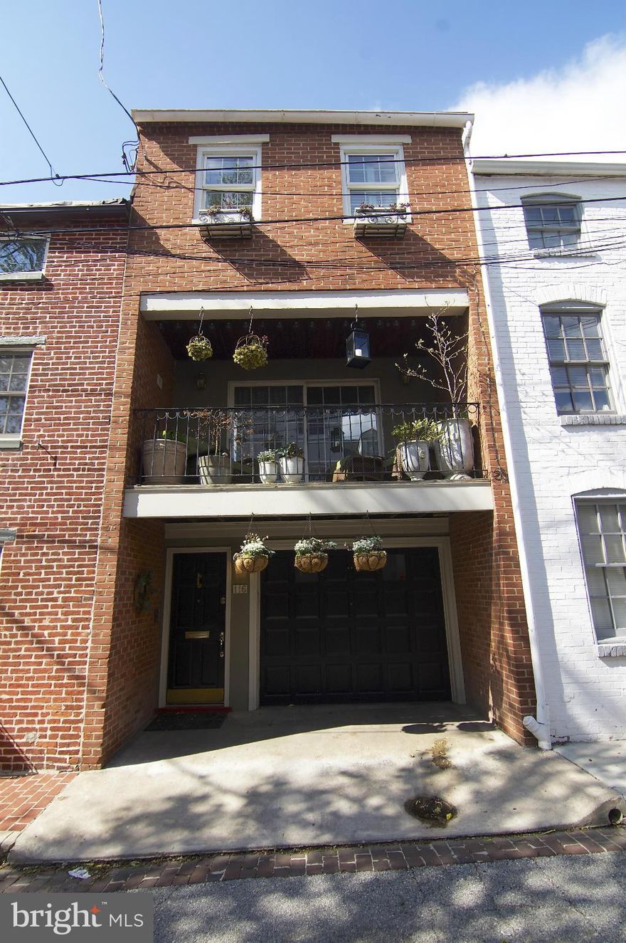 Rarely available garage Townhouse 1 block from Federal Hill Park on quaint Churchill Street. Two-side brick fireplace separates  second level Living room and  large Dining/Kitchen area. Exposed brick and beams. Wood floors throughout. Covered balcony off of LR. Built-ins in 2nd BR. One-car garage, storage and work shop on main level.