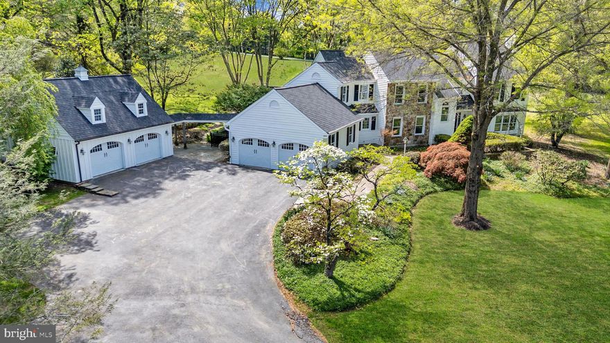 Welcome to 701 Haldane Drive, a beautifully renovated custom home set on 3.3 scenic acres in the award-winning Unionville-Chadds Ford School District, tucked within the exclusive 11-home Haldane community just minutes from Kennett Square, West Chester, and Longwood Gardens. This exceptional 4-bedroom, 2.5-bath residence blends timeless Chester County character with extensive recent upgrades including a brand-new gourmet kitchen, newly remodeled bathrooms, new septic system, new roof , and fresh interior and exterior paint. A dramatic cathedral two-story foyer welcomes you inside, where freshly refinished hardwood floors span the main level. The impressive great room features exposed beam detail, recessed lighting, ceiling fan, large panoramic windows, and a striking stone fireplace with gas insert and wood mantel, while the formal living room offers a brick gas fireplace and the elegant dining room showcases crown molding and classic wainscoting. The completely renovated gourmet kitchen is a standout with brand new GE Café appliances, six-burner gas cooktop with vented hood, double wall ovens, built-in microwave, quartz countertops, tile backsplash, deep sink, new cabinets with soft-close cabinetry, pantry, breakfast area, and bar space, and opens seamlessly to a tiled mudroom with built-ins, spacious laundry room with sink and included front-load washer and dryer, and a bright sunroom leading to the bluestone patio for ideal indoor-outdoor living. A private main-level office with floor-to-ceiling built-ins adds flexibility for today’s lifestyle, while upstairs a turned staircase with oak treads and painted risers leads to a loft overlooking the foyer and great room and a spacious primary suite featuring hardwood floors, crown molding, walk-in closet with custom shelving, and a luxurious bath with soaking tub, oversized glass-enclosed tile shower, and quartz vanity tops, complemented by three additional generously sized bedrooms and a brand new hall bath with tile surround tub/shower and quartz double vanity. Additional highlights include a perimeter basement waterproofing system, attached two-car garage plus a detached two-car carriage house with loft storage and new board-and-batten siding, and a beautiful slate courtyard with retaining wall—all set in one of Chester County’s most desirable and convenient locations.