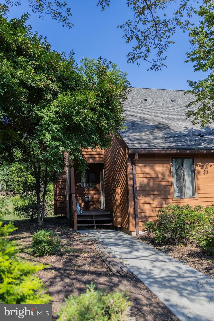 Welcome to the Woods! This stunning 3-bedroom, 3-bathroom end unit has just been freshly painted and features new flooring throughout. It's a beautiful two-level villa boasting a fantastic view of the 18th Fairway at the Woods Resort! Conveniently located within walking distance to the pro shop, a popular neighborhood restaurant, and the outdoor pool, this unit is tucked away in a charming community that will make you feel right at home. 

On the main level, you'll find luxury vinyl plank flooring in the spacious living area, which includes a large bedroom with an attached bath on one side, and an open family living/dining area, complete with a cozy wood-burning fireplace, on the other. The kitchen is equipped with custom cabinetry, granite countertops, and stainless steel appliances. The main-level balcony offers a perfect spot for entertaining.

Upstairs, the primary suite features a full bath, skylight, vaulted ceilings, and ample closet space, along with its own balcony. A generously sized secondary bedroom also includes a large attached bath. For added convenience, the laundry center is located on the upper level. The HVAC system and water heater were replaced just a few years ago. Below, a walk-in crawlspace provides plenty of exterior storage. 

HOA fees cover exterior maintenance, landscaping, and a trash drop-off facility. Experience the ultimate in relaxation at the Woods Resort—this property is perfect for living or could serve as a fantastic nightly rental!