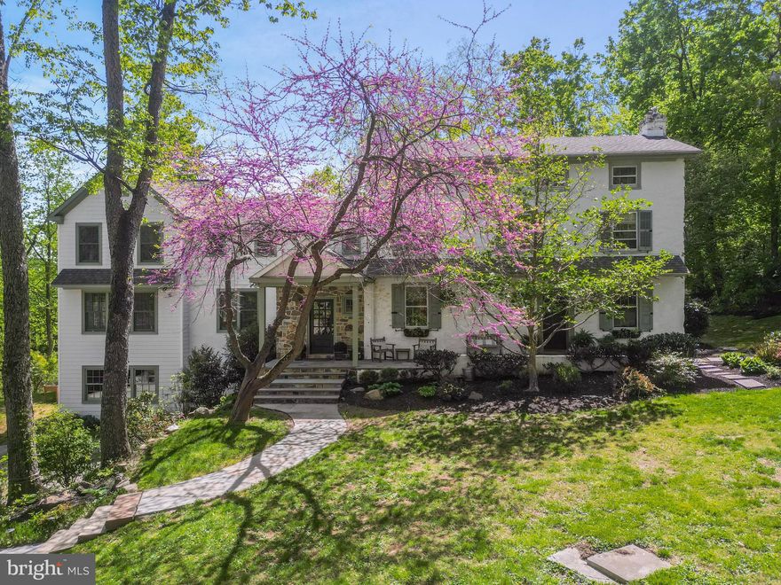 Set in Radnor Township, this 5-bedroom, 3-story farmhouse is a compelling blend of architectural legacy and thoughtful modern living. Originally built in 1846, the home began as a substantial farmhouse—part of the area’s deep agricultural roots—and evolved over the decades with additions that reflect the architectural styles of their time. The result is a home with depth, character, and integrity, unified by beautiful stonework, deep window sills, exposed interior stone walls, custom paneling, and wide-plank floors.
The current owner, a skilled craftsman, has guided the home's updates with an expert hand and a discerning eye. At the center of daily life is a bright, white kitchen, anchored by a striking navy blue seated island and outfitted with a suite of high-end appliances. This space flows seamlessly into a casual dining area and a stunning family room wrapped in three walls of oversized windows. Bathed in natural light throughout the day, this open, airy space has become the heart of the home.
For quieter moments, a warm and moody library/den is tucked off one of the home’s two foyers—a perfect setting for focused work, reading, or relaxed fireside evenings. The second foyer, styled with a shiplap ceiling, stone flooring, and an exposed stone wall, draws attention to one of the home’s original exterior windows—now a unique and charming interior feature that speaks to the property's layered history.
Just beyond the more formal of the two entries lies what was once the original parlor—now styled as a refined sitting room that transitions easily to a formal dining space when the occasion calls. The room’s generous proportions and architectural detail allow it to function beautifully in both roles.
A separate bar room adds yet another distinctive feature. Here, a brick-surround fireplace original to the home (now decorative) anchors the space, while expansive prep counters and glass display cabinetry make it both functional and visually striking—a space equally suited to entertaining or everyday elegance.
Upstairs, the primary suite offers quiet luxury, with wide-plank floors, spacious closets, and deep window sills that flood the room with soft natural light. The en-suite bath features a large walk-in shower, double vanities, and custom finishes that elevate the space. Two additional bedrooms share a hall bath that’s a true showstopper—featuring an exposed stone wall, a custom vanity with a vessel sink, and warm wood flooring that highlights the home’s enduring farmhouse character. The third floor offers two more bedrooms and a full bath—ideal for guests, home office use, or flexible family living.
Located within the top-ranked Radnor Township School District, this home offers a rare opportunity to own a piece of local history—refined and reimagined for today’s lifestyle. With timeless materials, handcrafted finishes, and spaces that welcome both everyday living and elegant entertaining, this is a Main Line classic brought beautifully into the present.